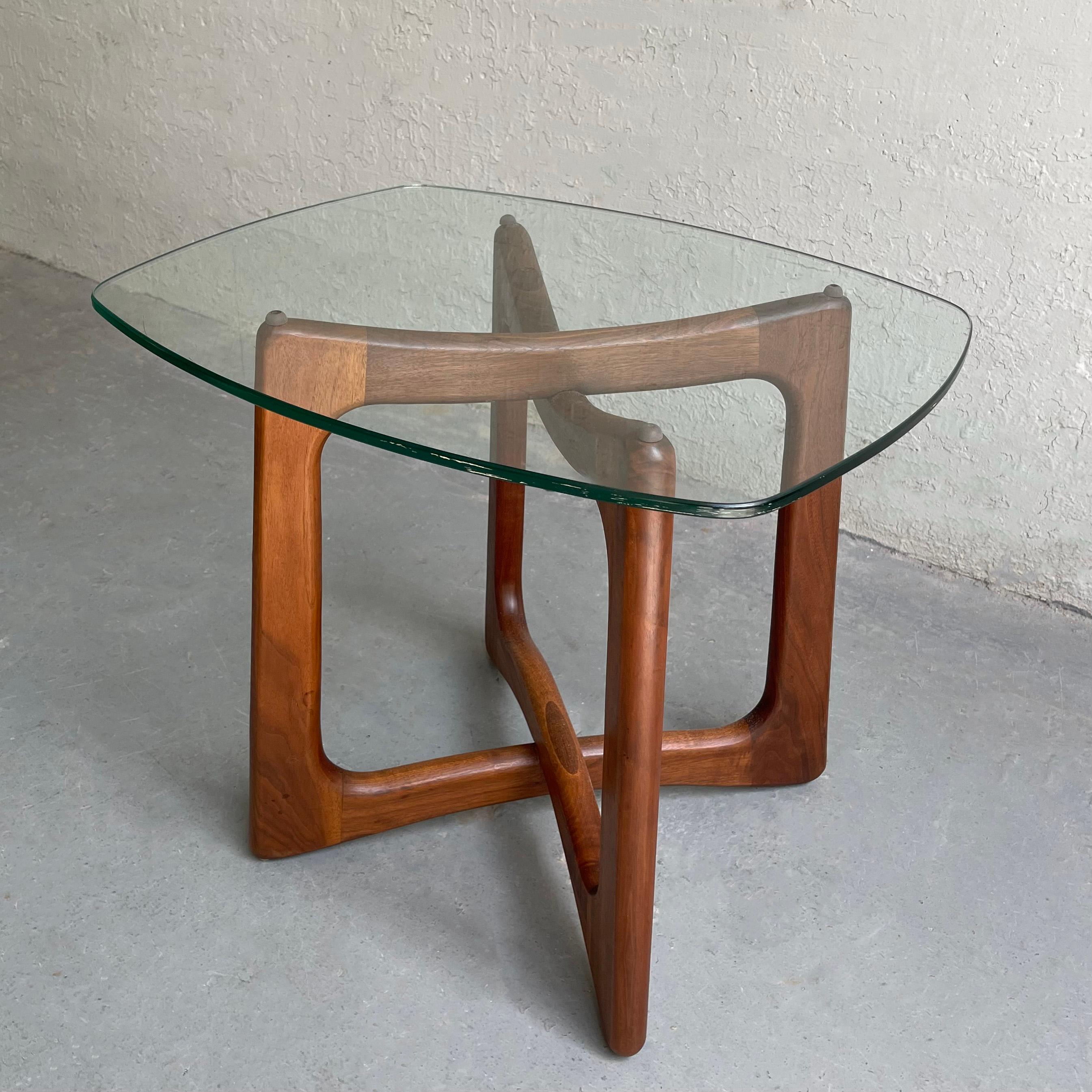Mid-century modern side table by Adrian Pearsall for Craft Associates features an intersecting, sculptural walnut base with contoured glass top. The Adrian Pearsall coffee table and chairs are listed separately.