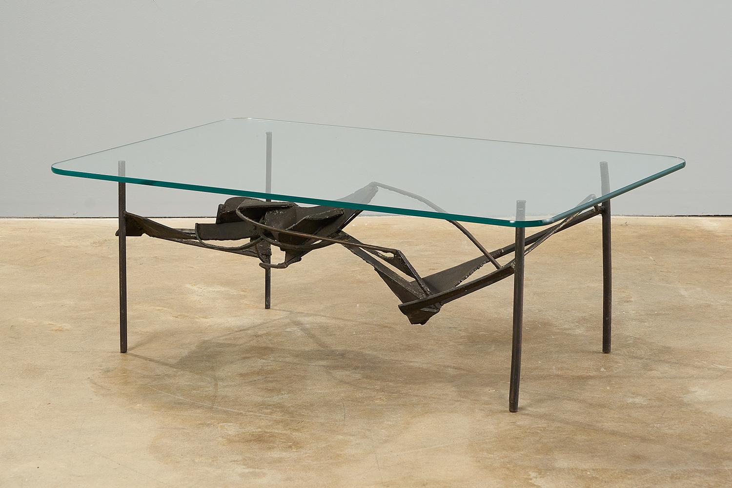 Really unusual welded steel coffee table with glass top. Artist made, unsigned to our eye. 