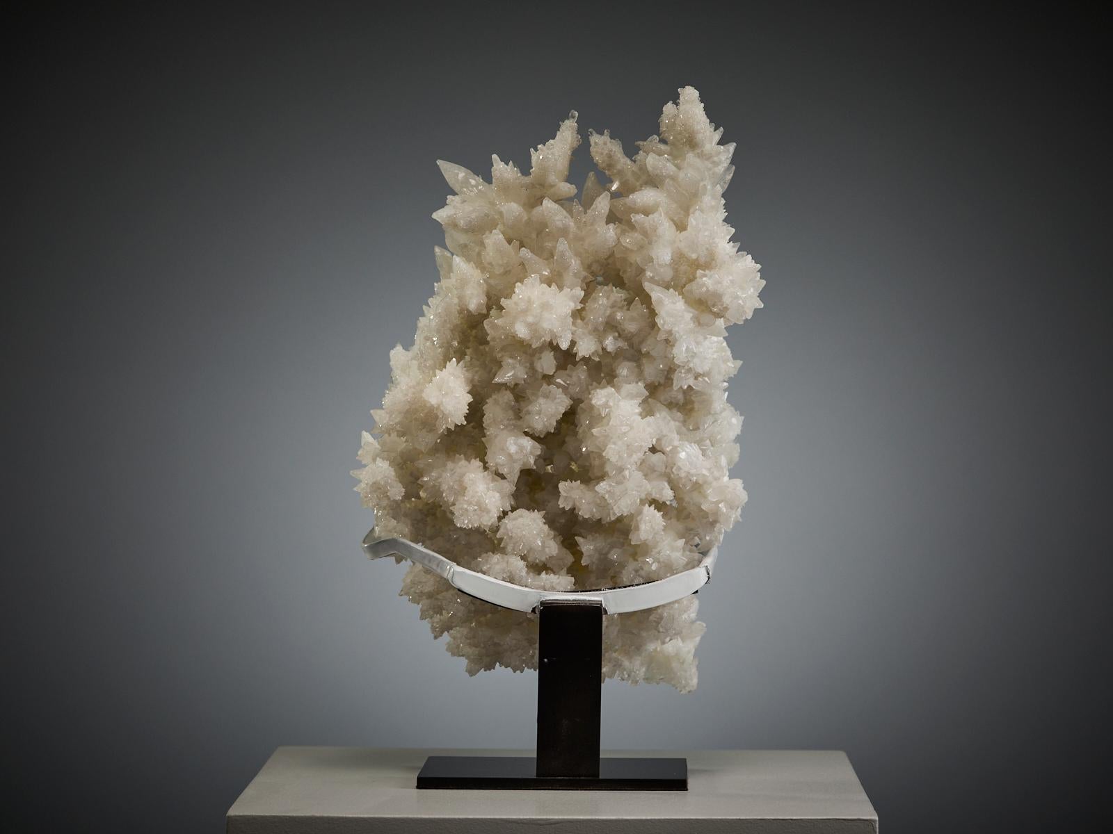 A magnificent sculptural specimen from Mexico, composed of intergrown calcite and aragonite crystals in a striking three-dimensional arrangement. The formation displays a variety of crystal habits and textures, creating depth and movement throughout