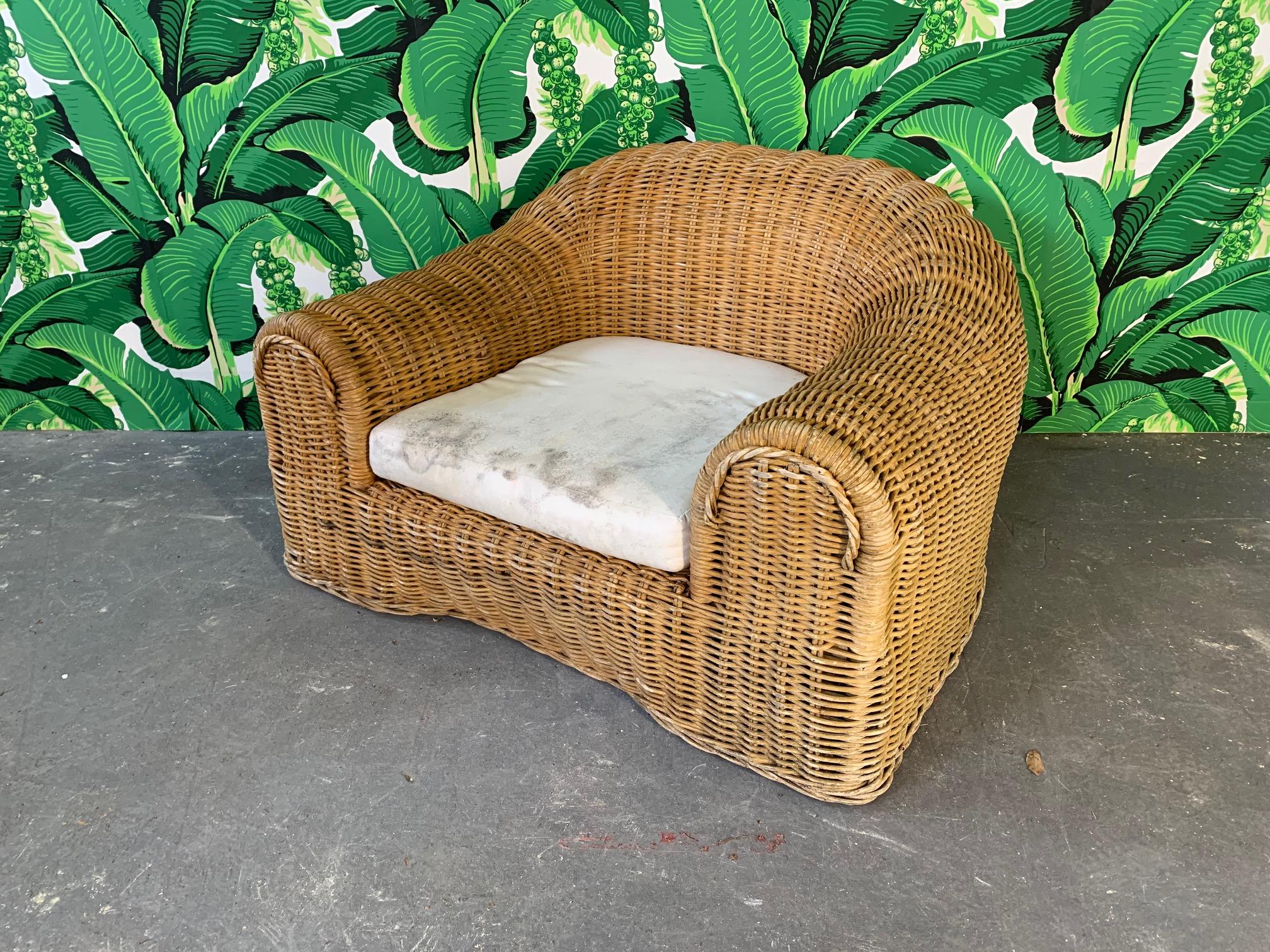 Sculptural wicker chair in the manner of Michael Taylor or Eero Aarnio. Good vintage condition with minor imperfections consistent with age. Includes cushion (has staining) but no upholstery.