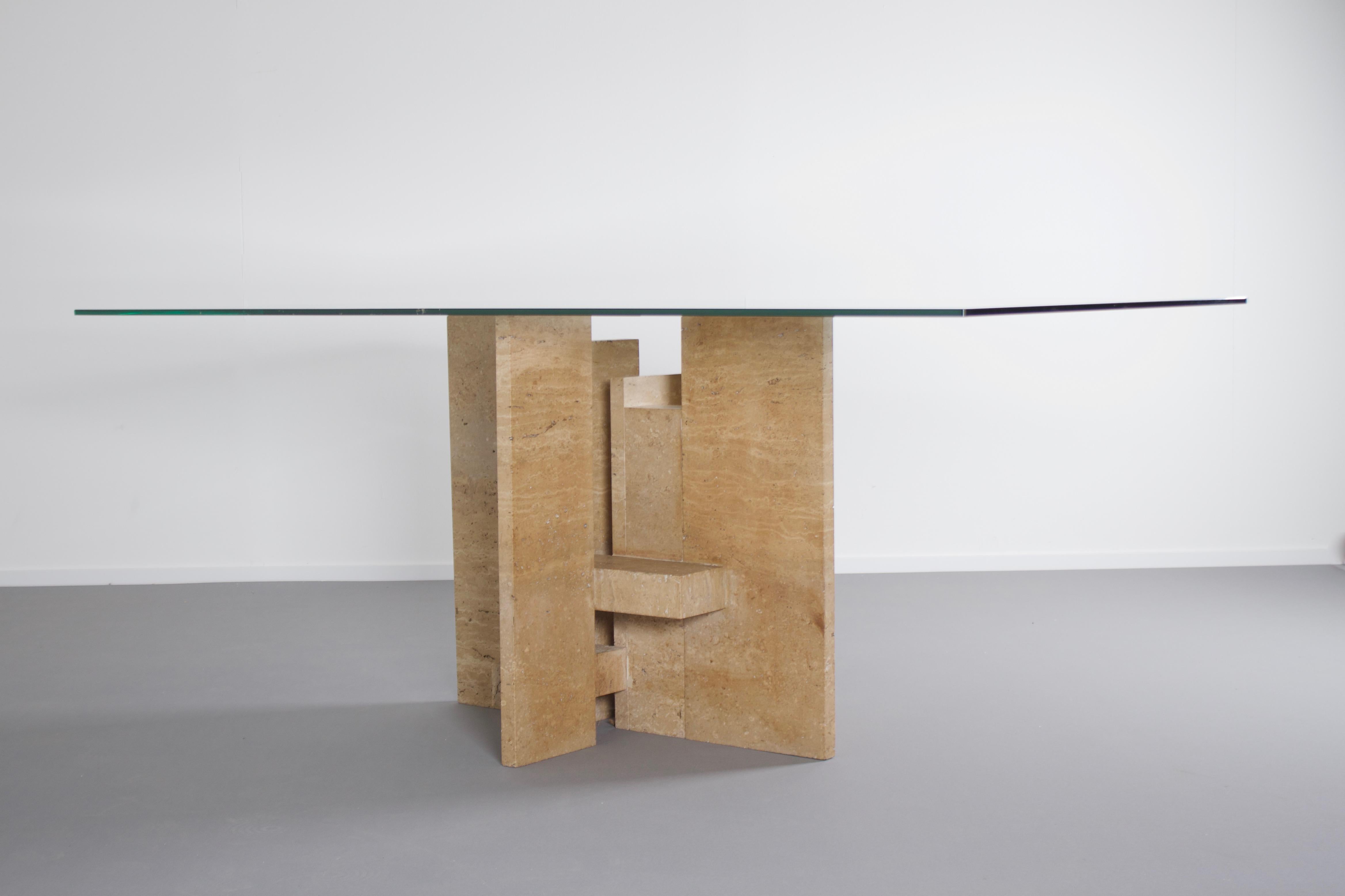 Impressive dining table by Studio Willy Ballez in very good condition.

Designed in Belgium in the 1970s this sculptural table is a an example of postmodern design.

The handmade abstract base is made from thick solid travertine slabs which are