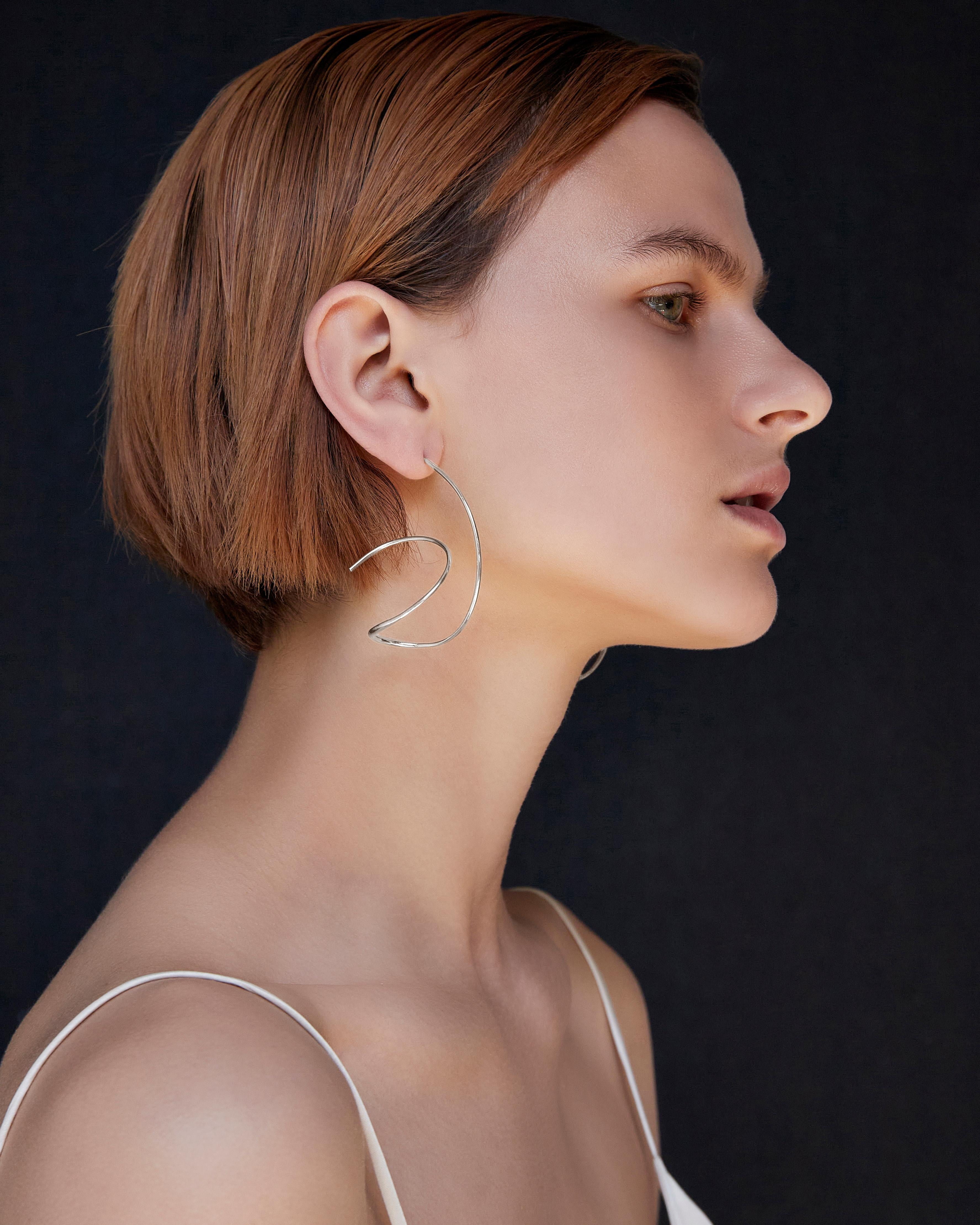 BAR Jewellery, London UK, RIVERA EARRINGS, Sterling Silver 

Inspired by the sculptor Jose De Rivera, the Rivera Earrings are lightweight, wearable sculptures. Best worn with the hair tied back away from the face to highlight the sculptural