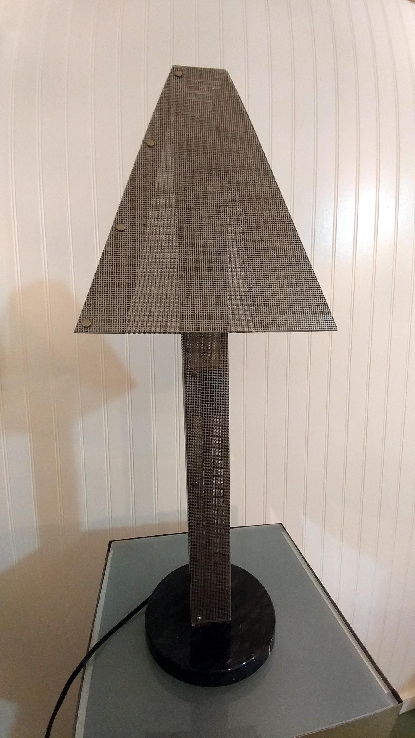 A great looking Postmodern sculptural table lamp by Wendy Stevens, offered by La Porte. This lamp is the taller version and is in exceptional condition. The shade and body crafted entirely in matte silver wire mesh on marble base. Illuminated as