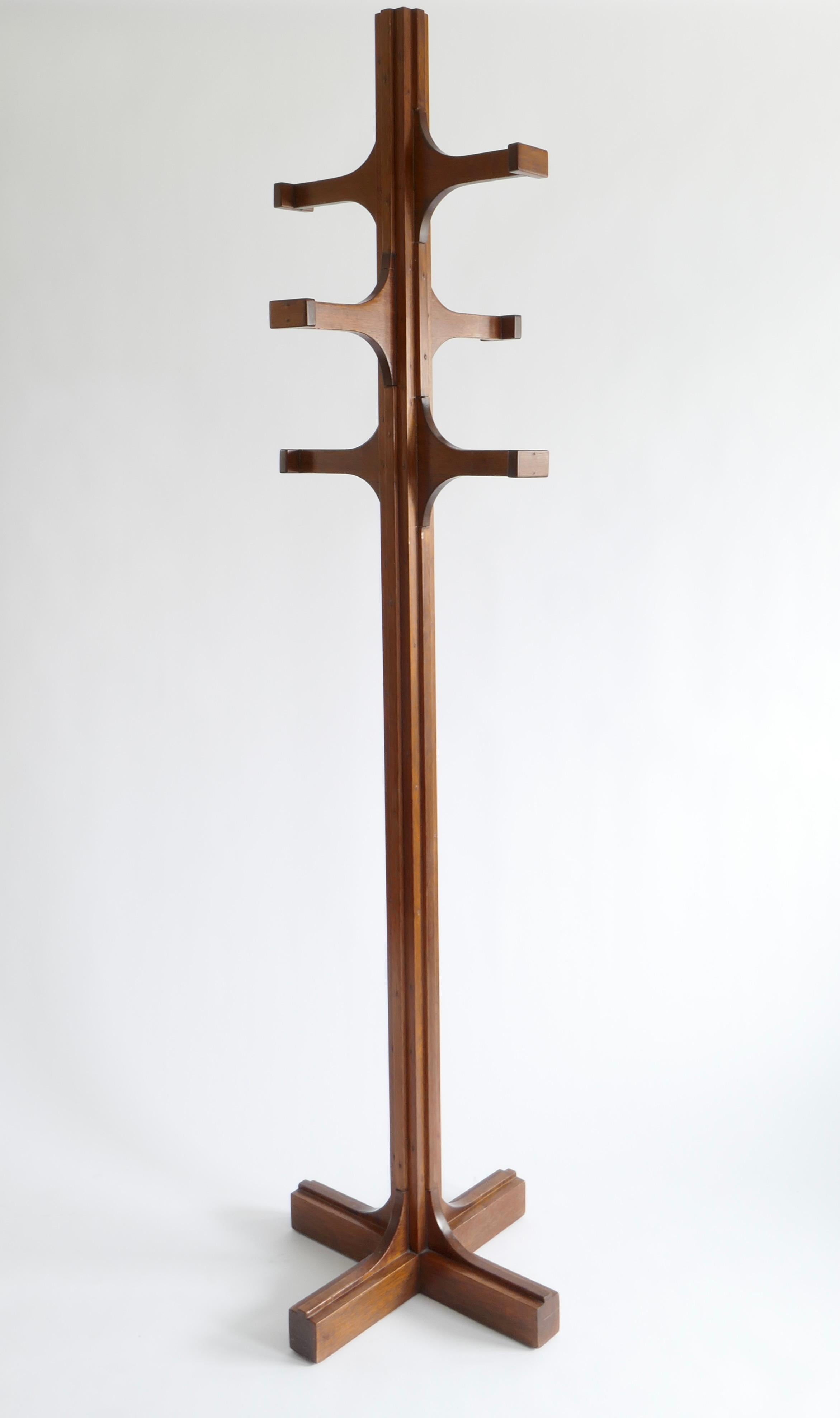 A tall sculptural coat stand designed by Giuseppe Rivadossi in the 1970s. 
The stand is made of patinated oak wood with a polished finish. Designed as a stylised TOTEM, this coat stand is both decorative and useful and an impressive statement piece