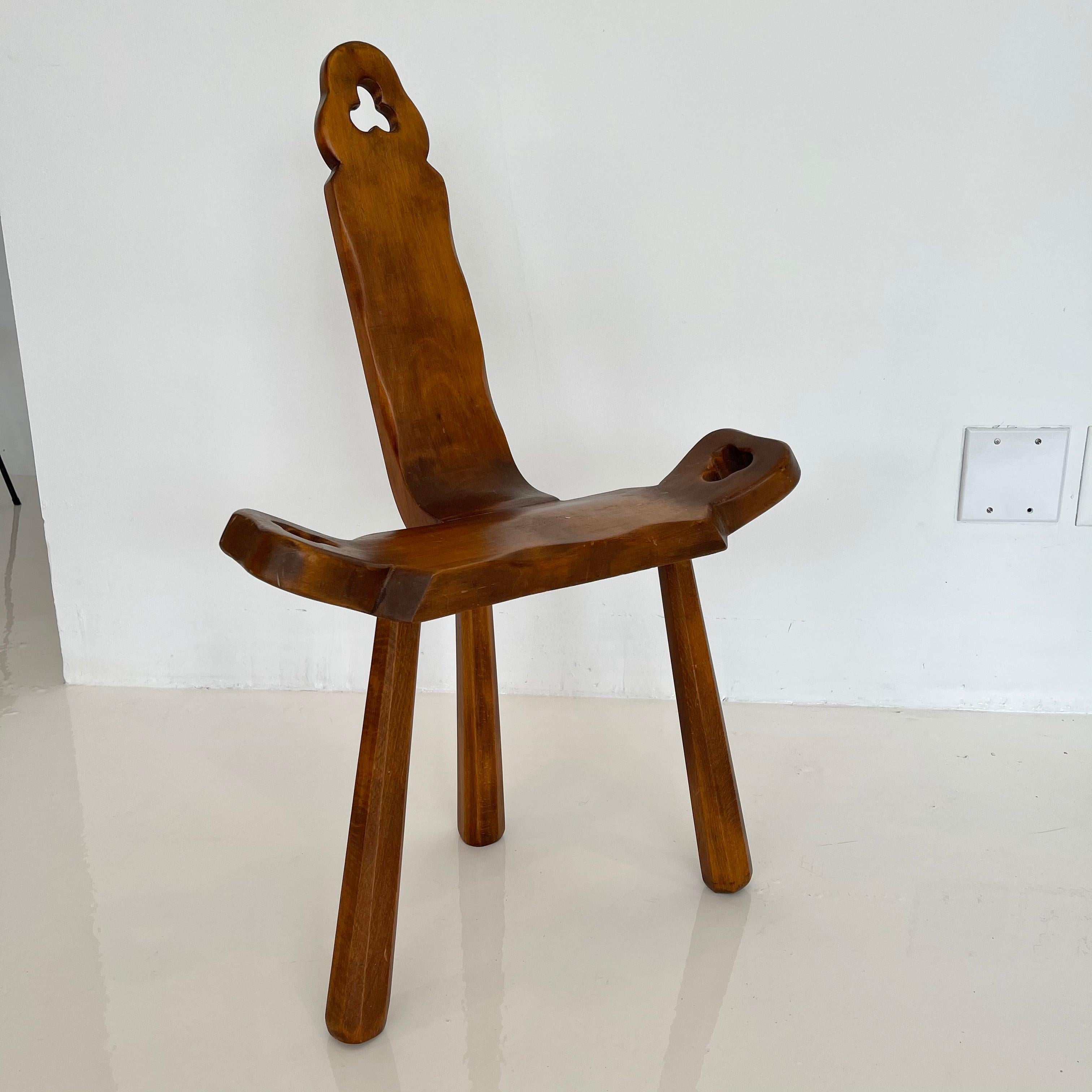 Interesting wood tripod chair from Spain. Notched holes in head rest and both arms. Historically used as a birthing chair. Great piece of functional sculpture. Good condition to wood. Slight lean which does not affect stability.