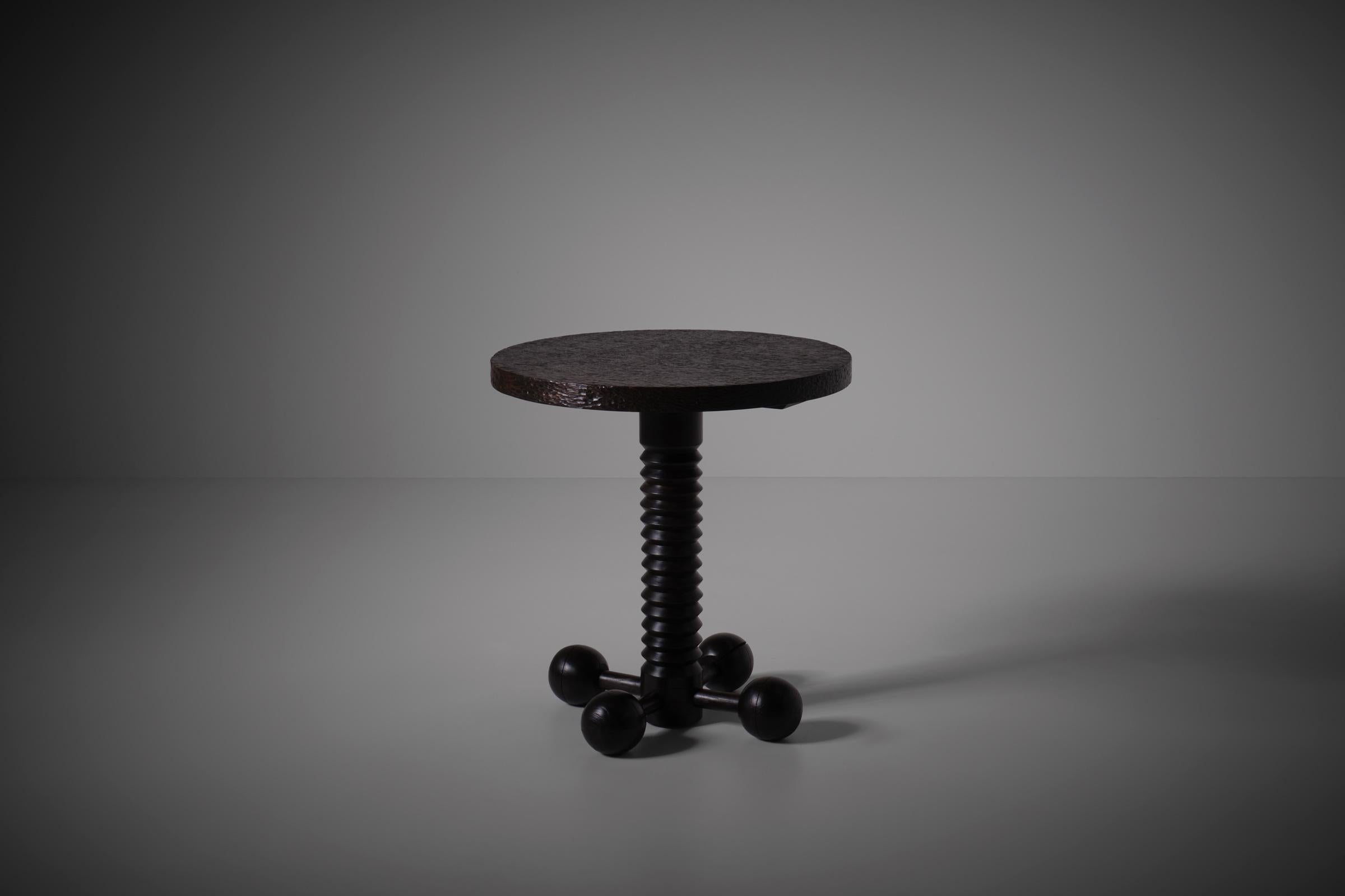 Sculptural wooden bistro table in solid Oak, France 1940s. The hand-carved dark stained round table top rests on a beautiful detailed base constructed out of a screw shaped center column with four nice contrasting ball feet. The variation in form,