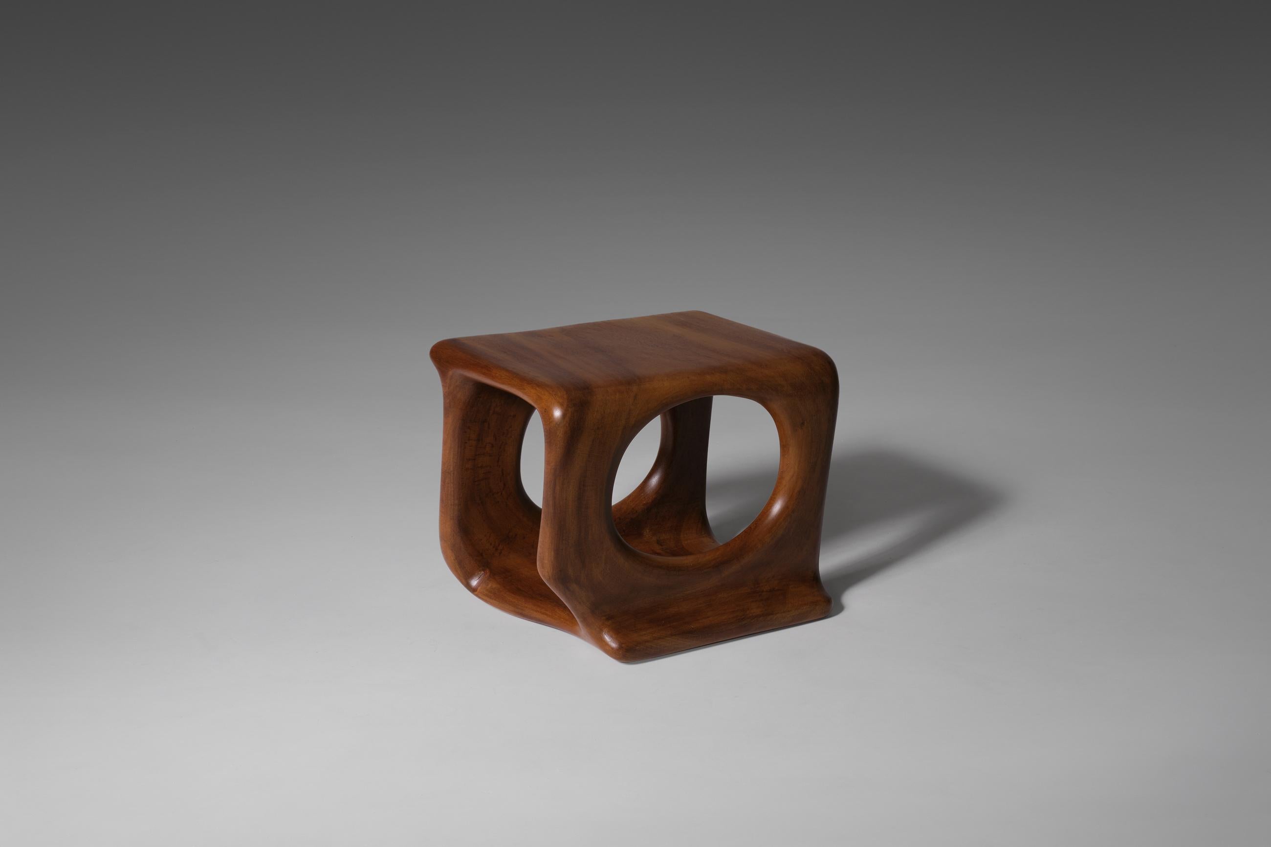 Unique sculptural wooden side table, 1970's. Reminiscent of the work of Wendell Castle. The table is hand carved out of a solid piece of Burma teak wood, the nicest and best quality of teak wood. Beautiful organic sensuous shapes which fluently flow