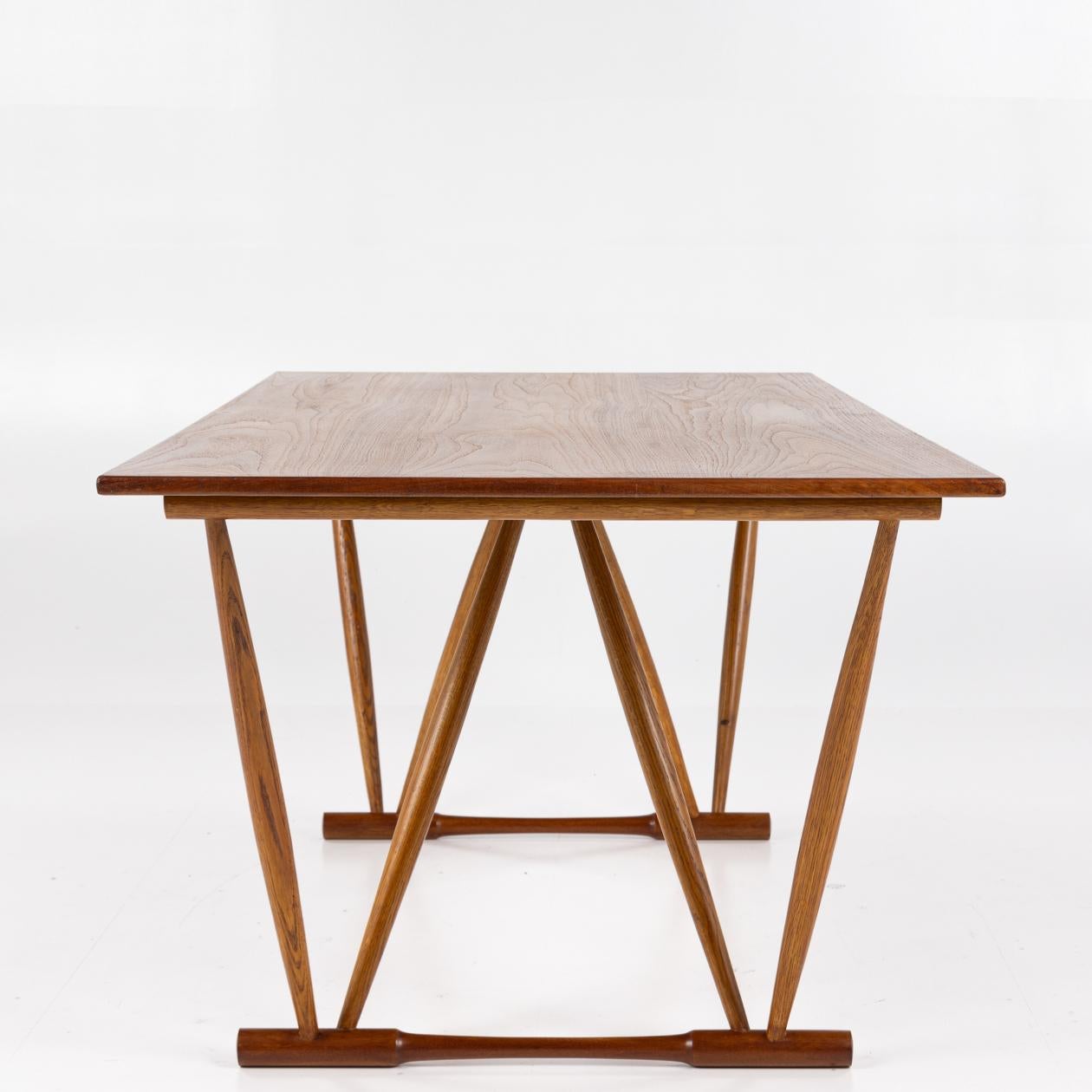 Sculptural work/dining table in teak and V-shaped legs in oak. Designed in 1944. Frode Hom / Illums Bolighus