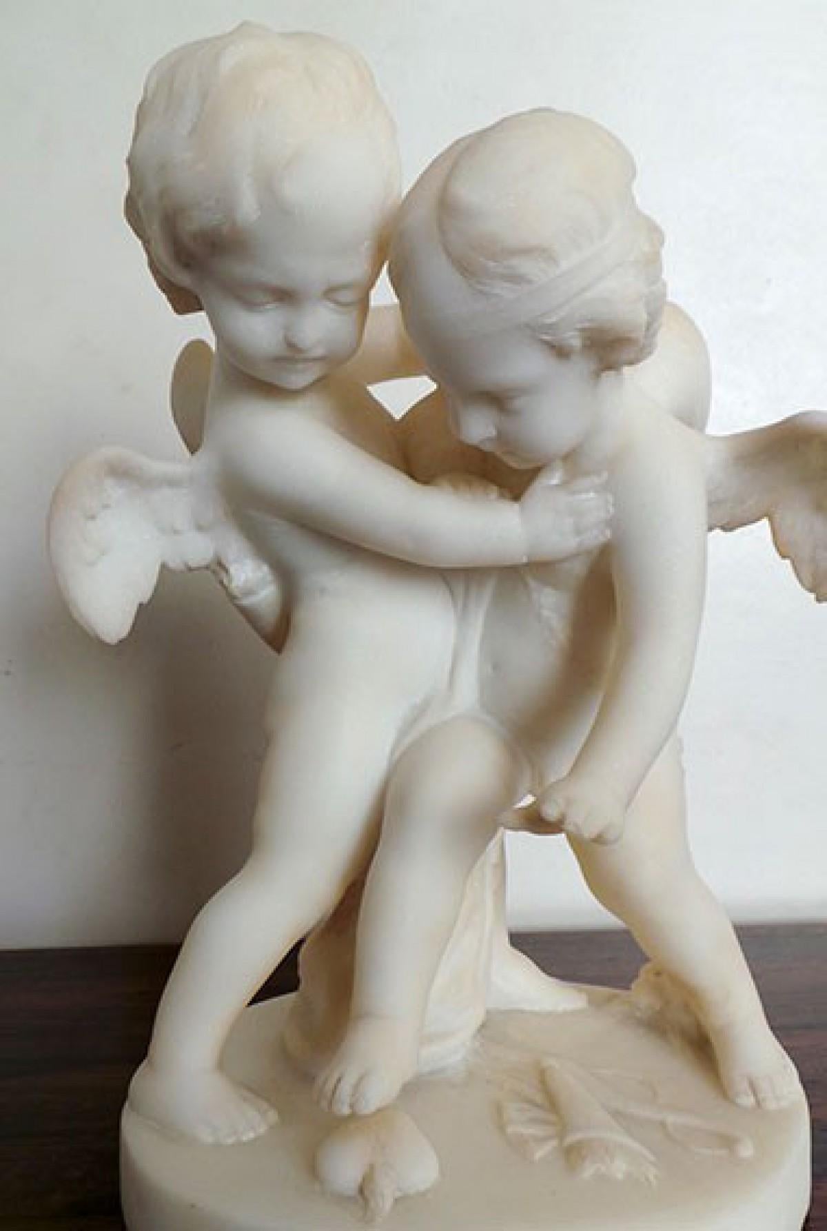 Beautiful alabaster sculpture after Jean Marie Pigalle, representing two cherubs, cupid, arguing for a heart-shaped pebble. Arrows and quivers on the ground. No signature probably late 19th-early 20th century. Measures: Height 32 cm, base 21 cm.