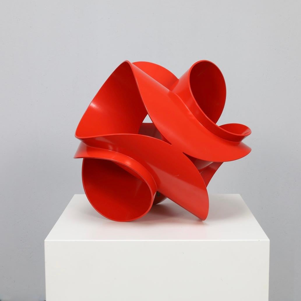 This sculptural work by Rob Zweerman, titled Axis, is a striking study in motion, line, and balance. Made of powder-coated steel in a vivid red tone, it unfolds like a three-dimensional drawing — fluid, dynamic, and sharply geometric.

Zweerman is