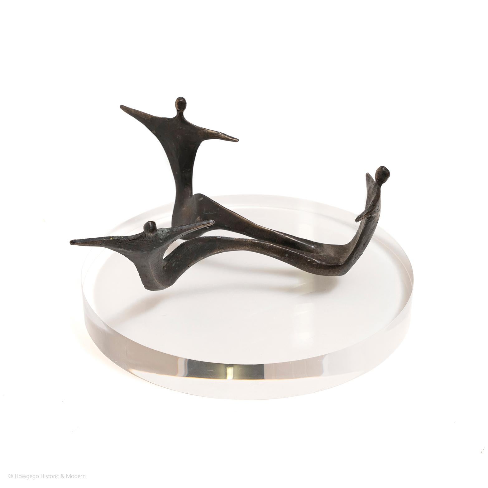 The distinctive pared down, forms of the three dancers as one entity creates a rhythmic fluidity in the composition and representing balance and unity. 

A modernist, biomorphic, bronze sculpture of three dancers as one form, legs intertwined