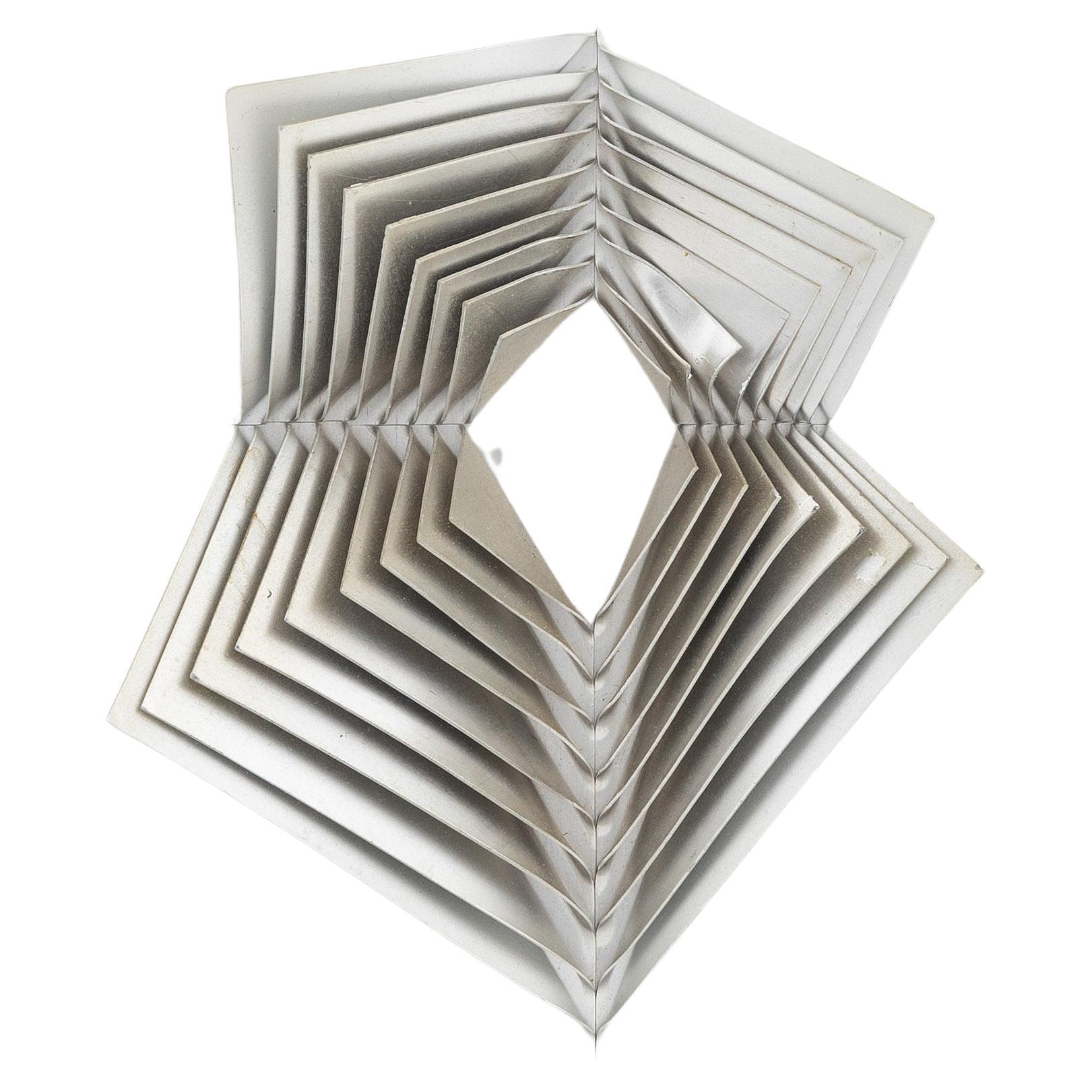 Aluminum wall sculpture by Swedish artist Arne Jones dating from the 1970s. Composed of 9 aluminum plates stacked and attached to each other by four rivets. This multiple is supposed to have been made at about 4000 copies. 3000 copies for the first