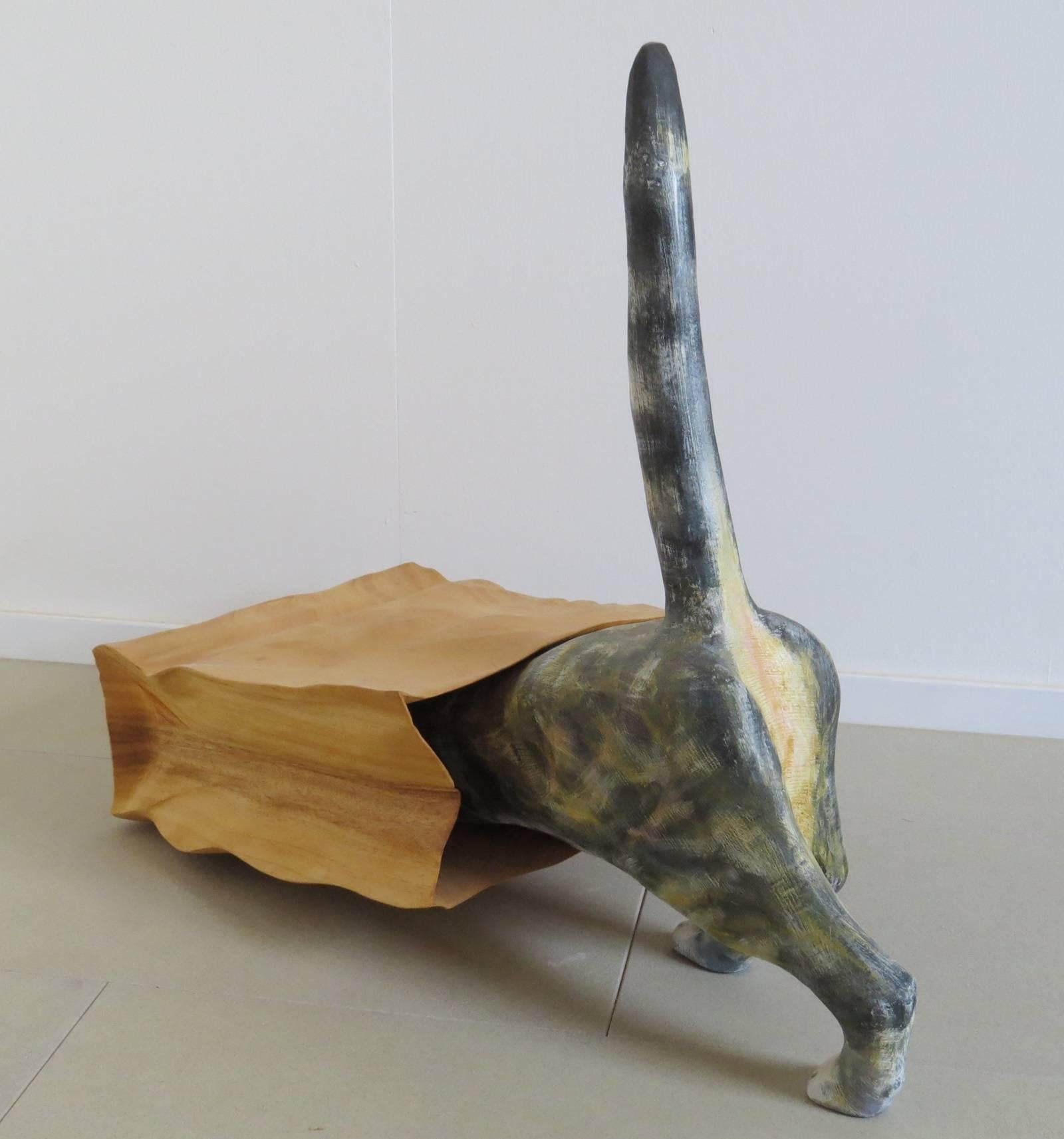 Not only for cat lovers.
Wooden sculpture hand-carved in original size.

Every cat owner knows this situation: The curious cat rummages through a grocery bag - here made as a sculpture.
The bag made of wood with folds and creases.
The cat