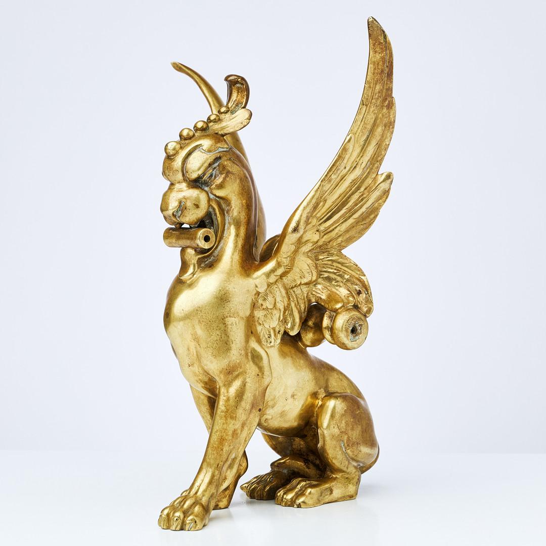 Decorative objects, brass, Asia, the winged lion, Griffin Pixiu, holes for former mounts and suspension, 20th century.

The winged lion is a mythical creature known in some cultures as the Griffin – a beast with lion and eagle features. It has been
