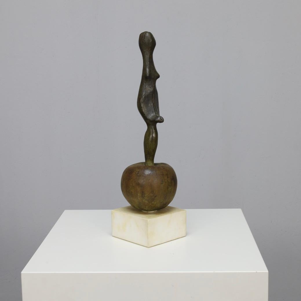 Godfried Pieters
Female Figure on Apple II, undated
Bronze on stone base
H 50 × W 13 × D 13 cm (approx.)

Highly abstracted female figure balanced on top of  a rounded apple form. The composition is vertical and totemic, rendered in bronze with a