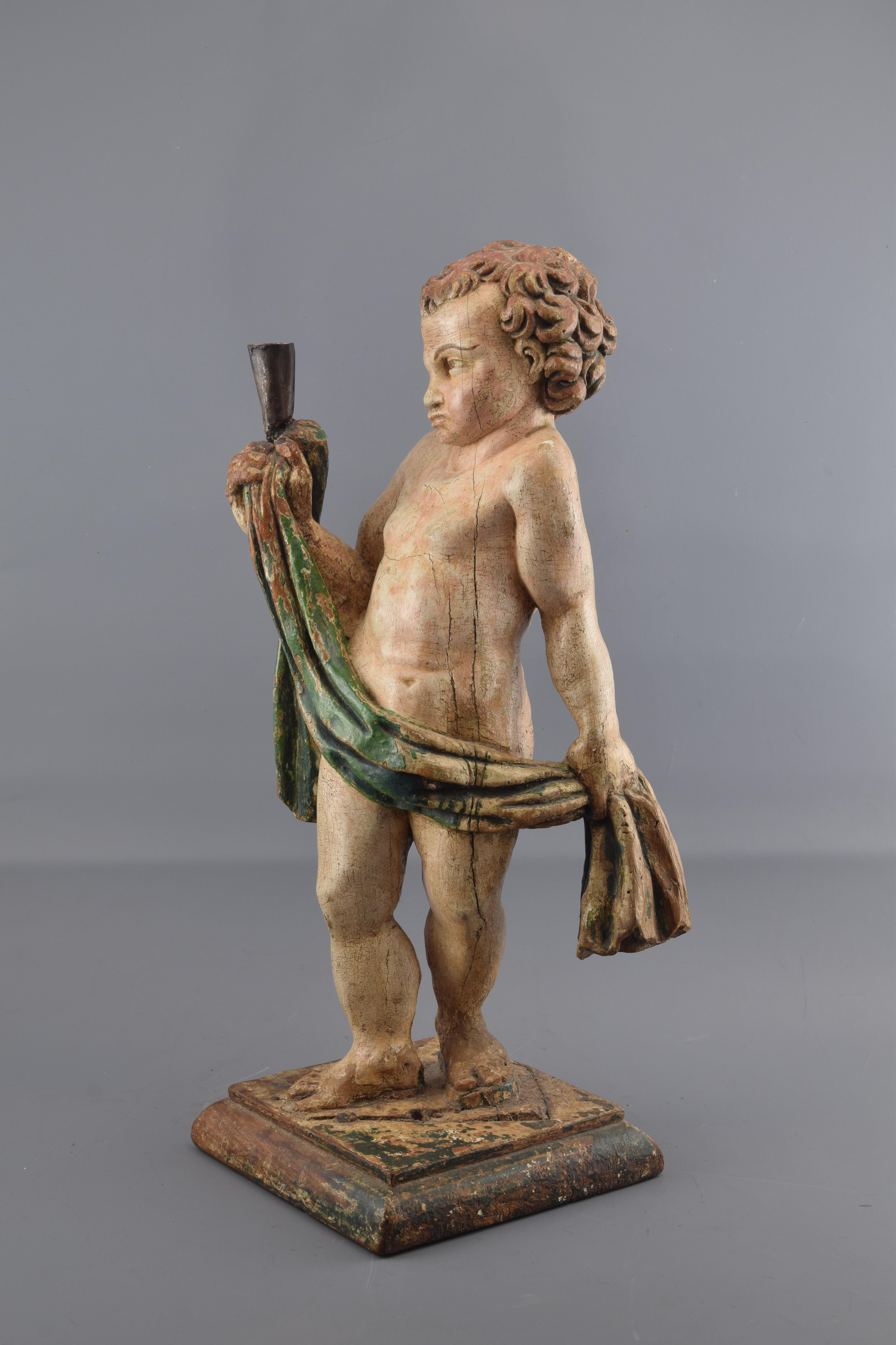 Sculpture (figural candlestick). Carved and polychrome wood, wrought iron. Castilian school, 16tyh-17th centuries.
Carved and polychrome wooden sculpture placed on a simple base showing a half-naked male figure, holding with his hands a cloth that