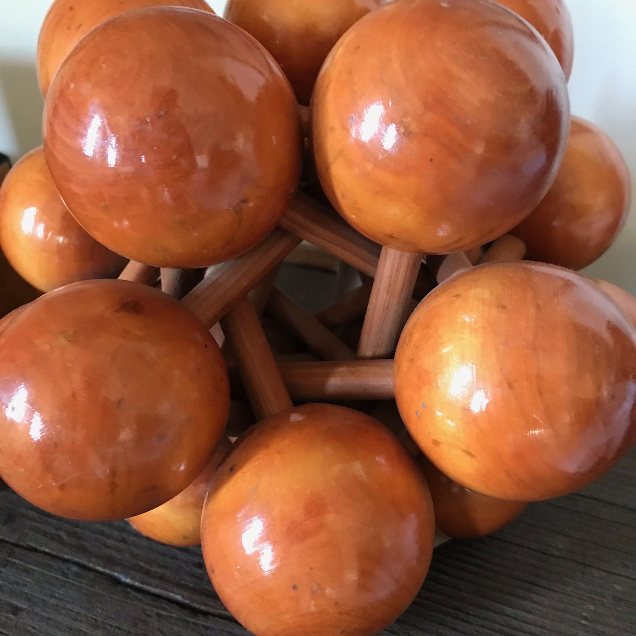 A wooden sculpture of balls.