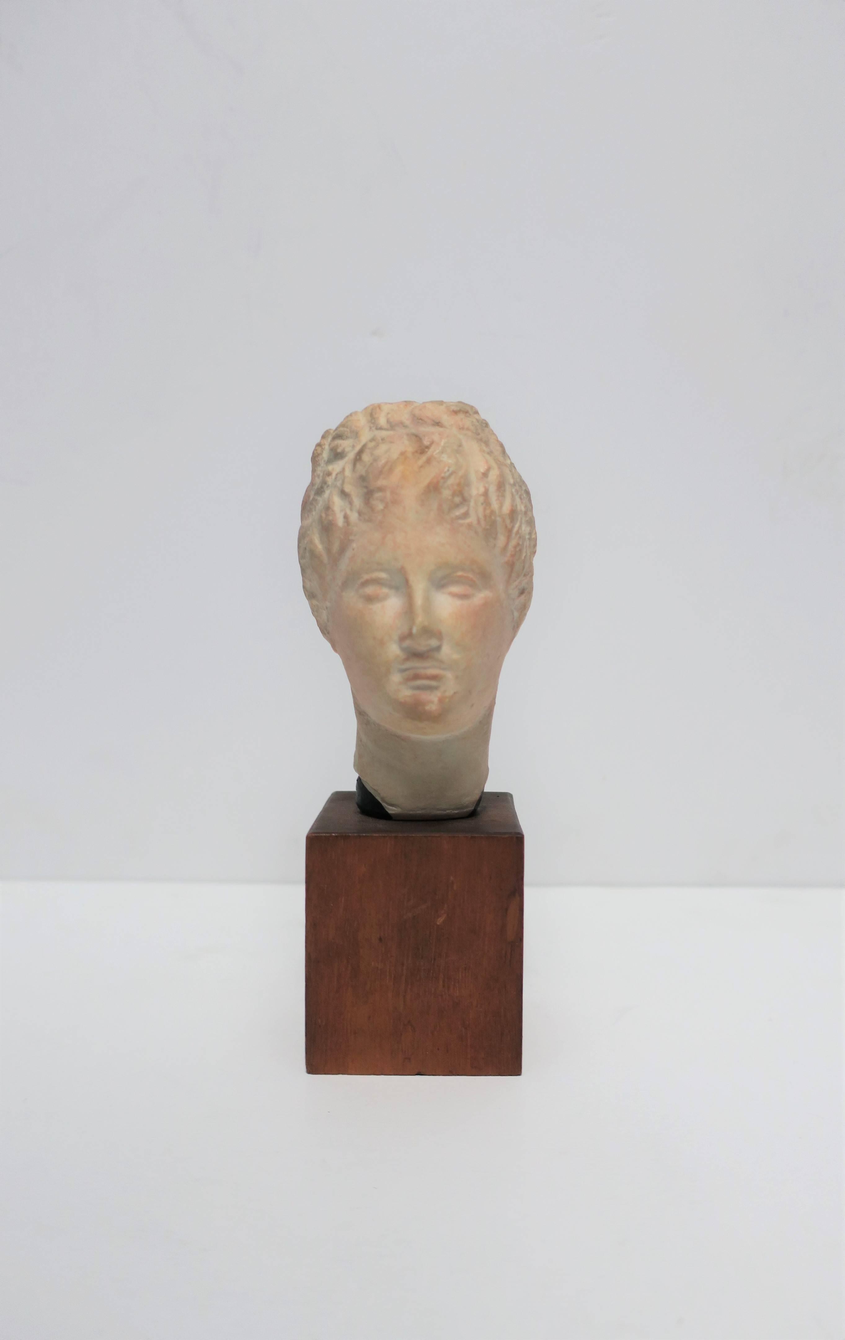 A small vintage English sculpture head or bust on wood base. This replica sculpture piece was made in England from an original featured at the Museum of Fine Arts, Boston MA (as reads on label, image #14.) 

Piece measures: 2.50