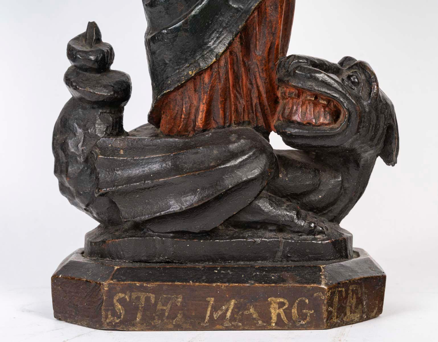 Français Sculpture en bois polychrome représentant Sainte Marguerite, 18e siècle. en vente