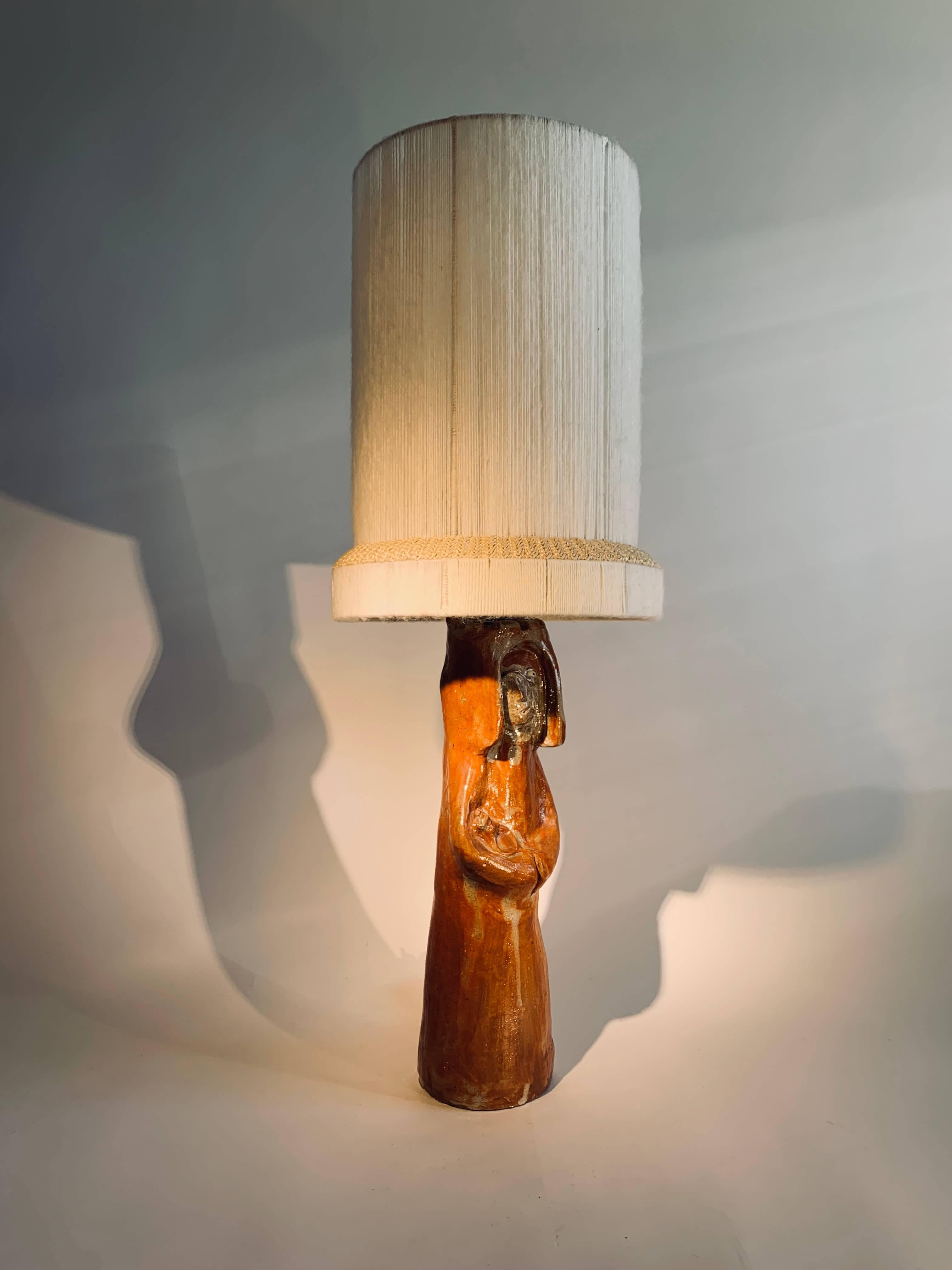 This imposing sculptural sandstone lamp, although large in size, 
exudes remarkable grace and softness. Sold with custom-made lampshades created by a French designer.
Excellent condition, unique piece, signed.
Sandstone, complete repair of
