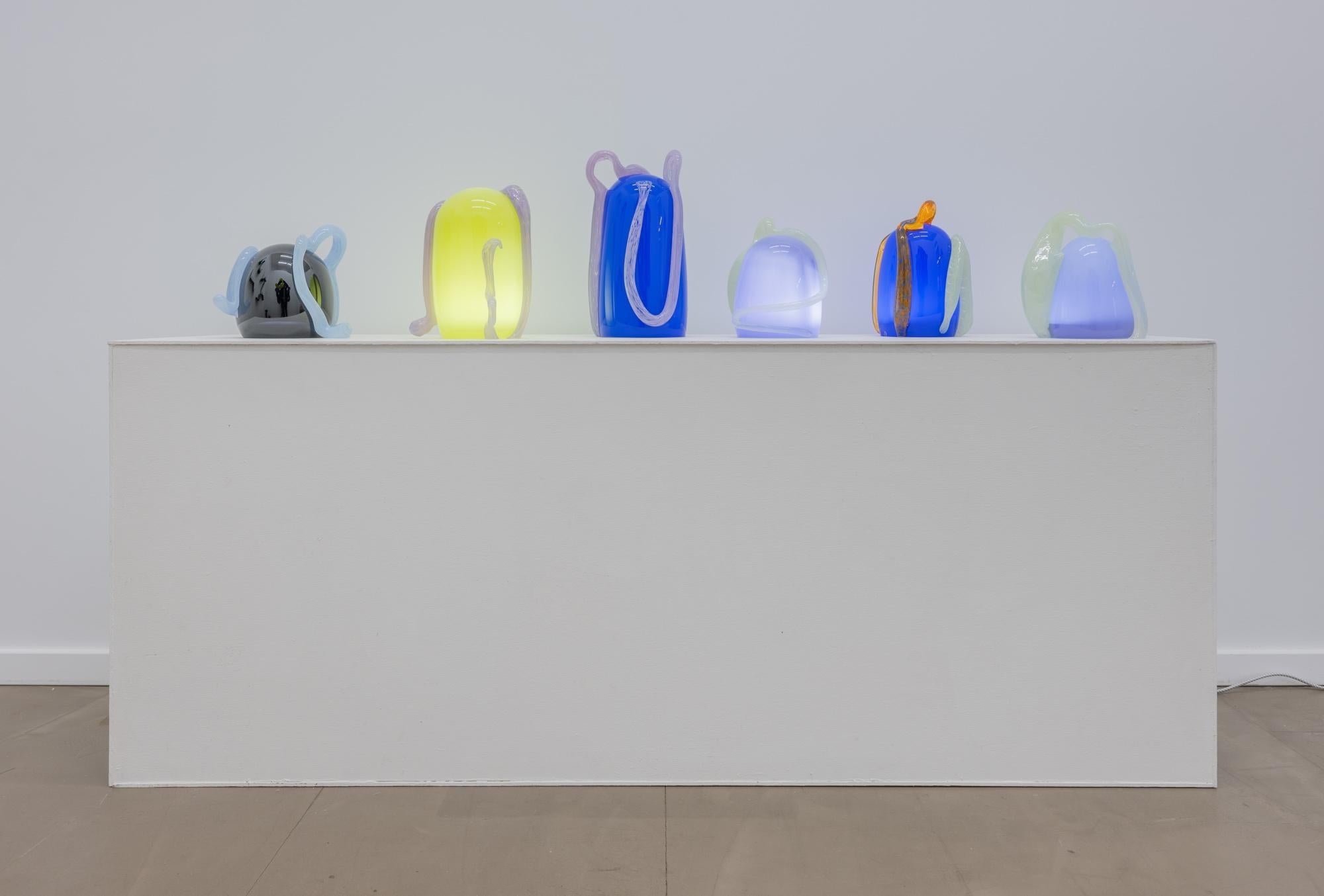 This work intends to highlight glass details, such as colors and patterns, that can be intensified when a light source is present.The glass sculptures are joyful through colors and grotesque through shapes. With a color palette of loud neons and