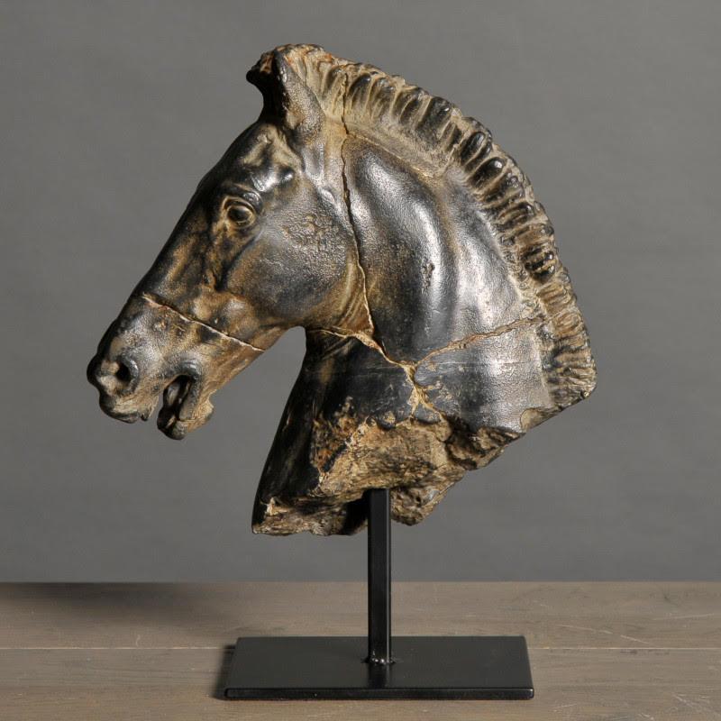Sculpture of a black horse's head.

This sculpture, taken from an original bronze statue created by Monti in the early 19th century, reveals all the animal's finesse and power.
This handmade piece has been aged and patinated by hand.

Material:
