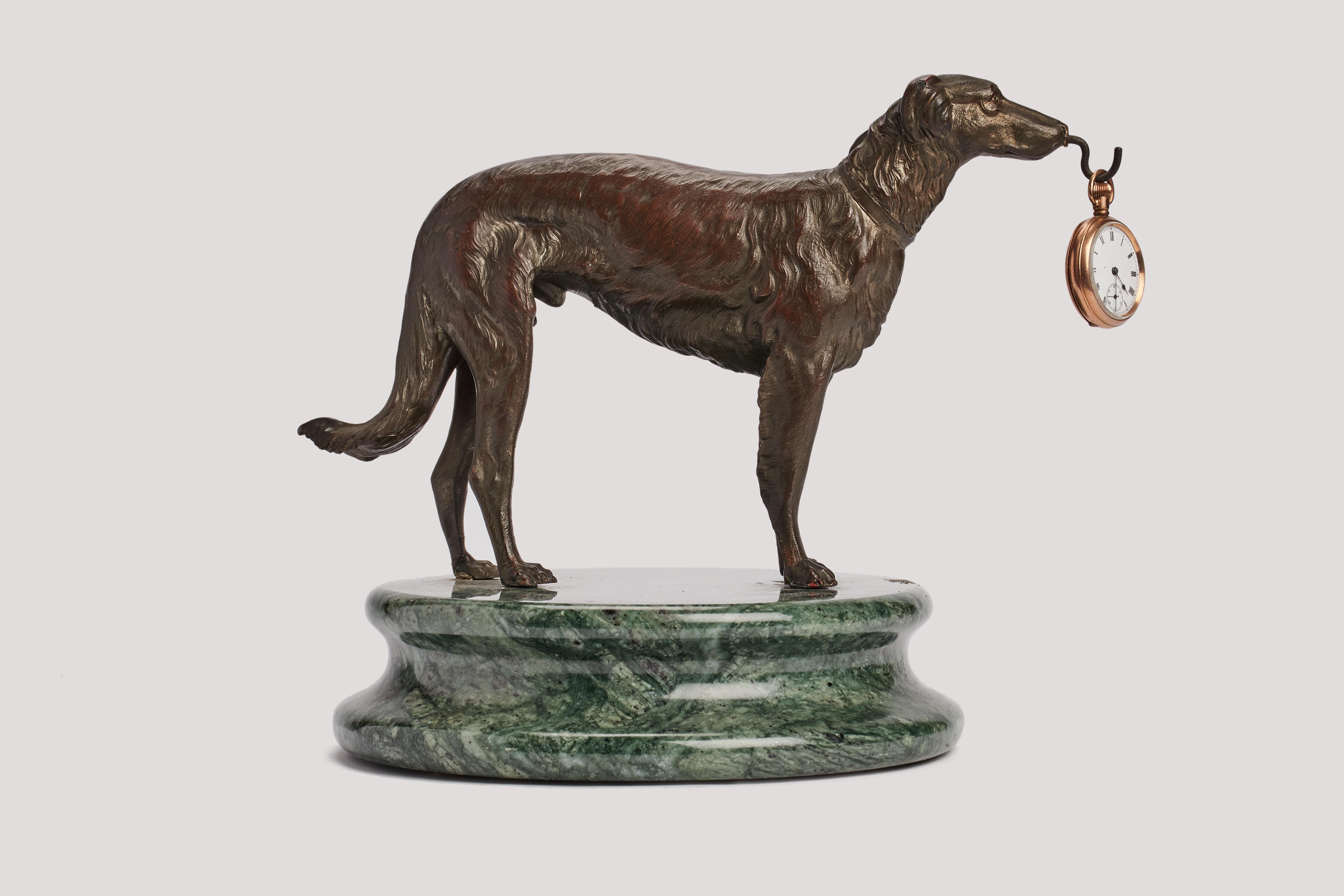A lost wax watch holder bronze, depicting a standing Borzoi greyhound, fully detailed. Circular green veined marble base. A hook holds the pocket watch. France circa 1880.