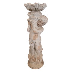 Sculpture of a Child with a French Terracotta Shell