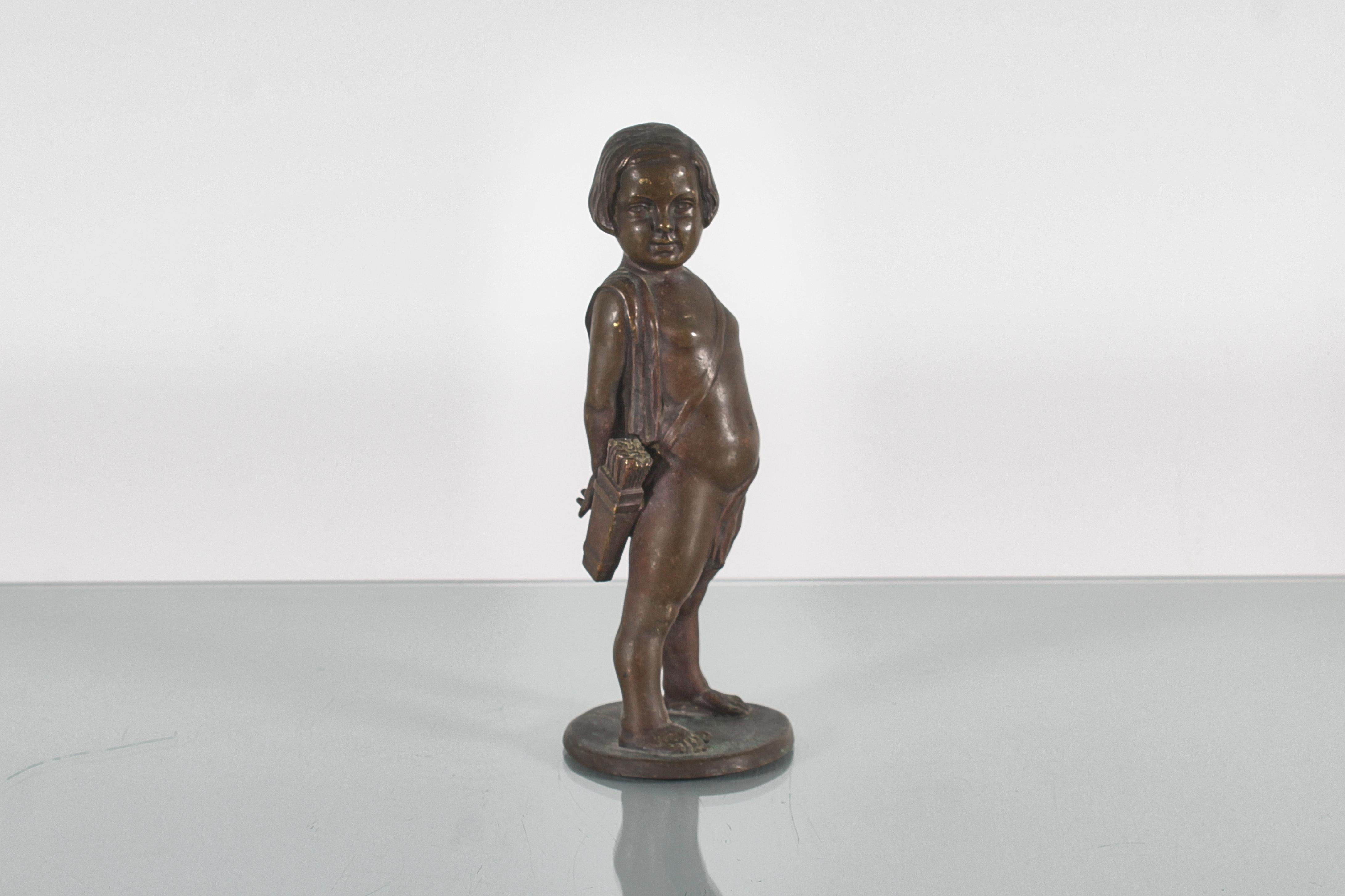 Italian Sculpture of a child with arrows in solid bronze signed. 1920s For Sale