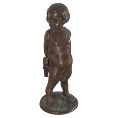 Escultura de un niño con flechas en bronce macizo firmada. 1920s