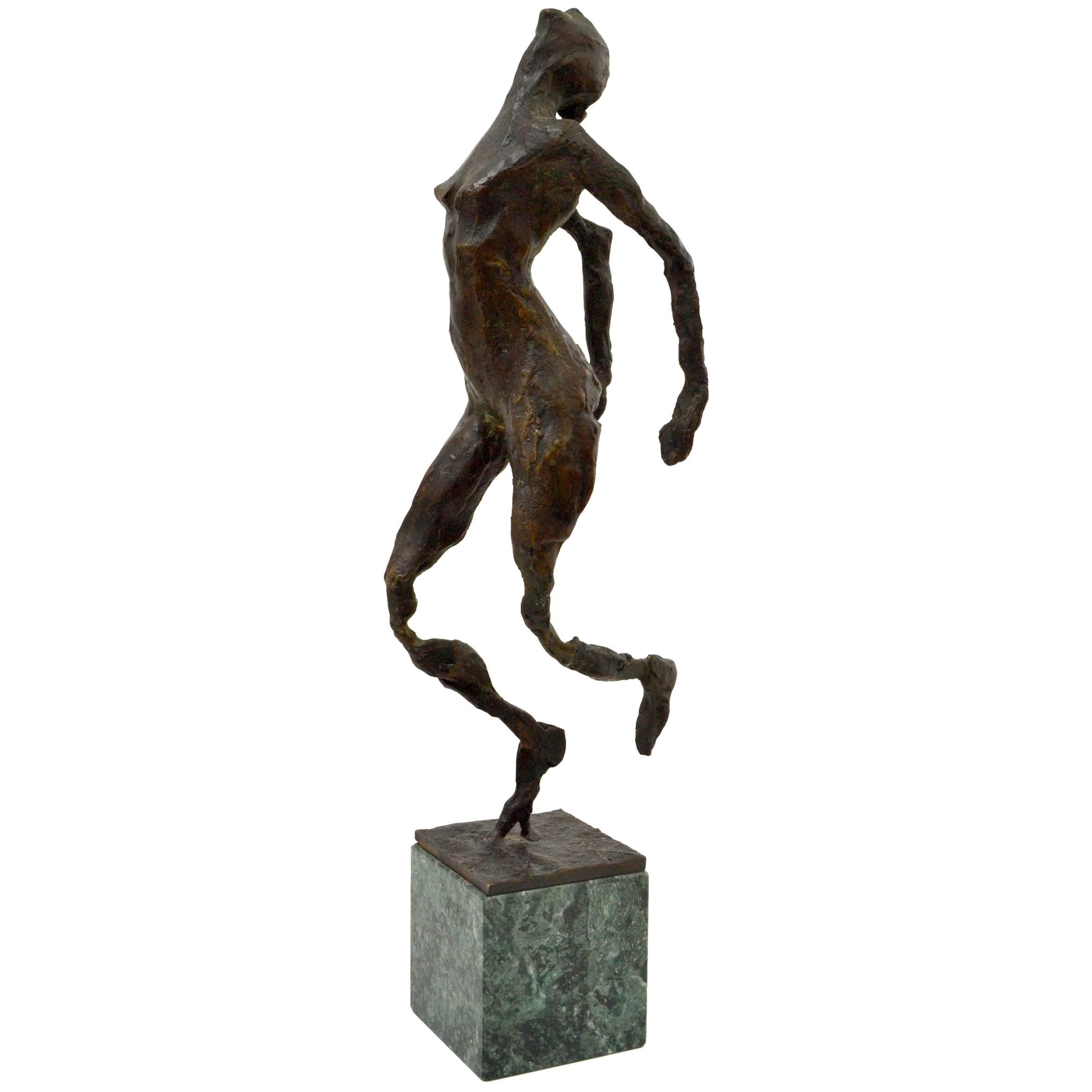 Bronze cast sculpture of female nude dancing figure placed on a green marble base is made by the Dutch artist M. Frijling.
The tactile and rough surface of the figure and the elongated and heavily worked arms and legs emphasis on the dynamic
