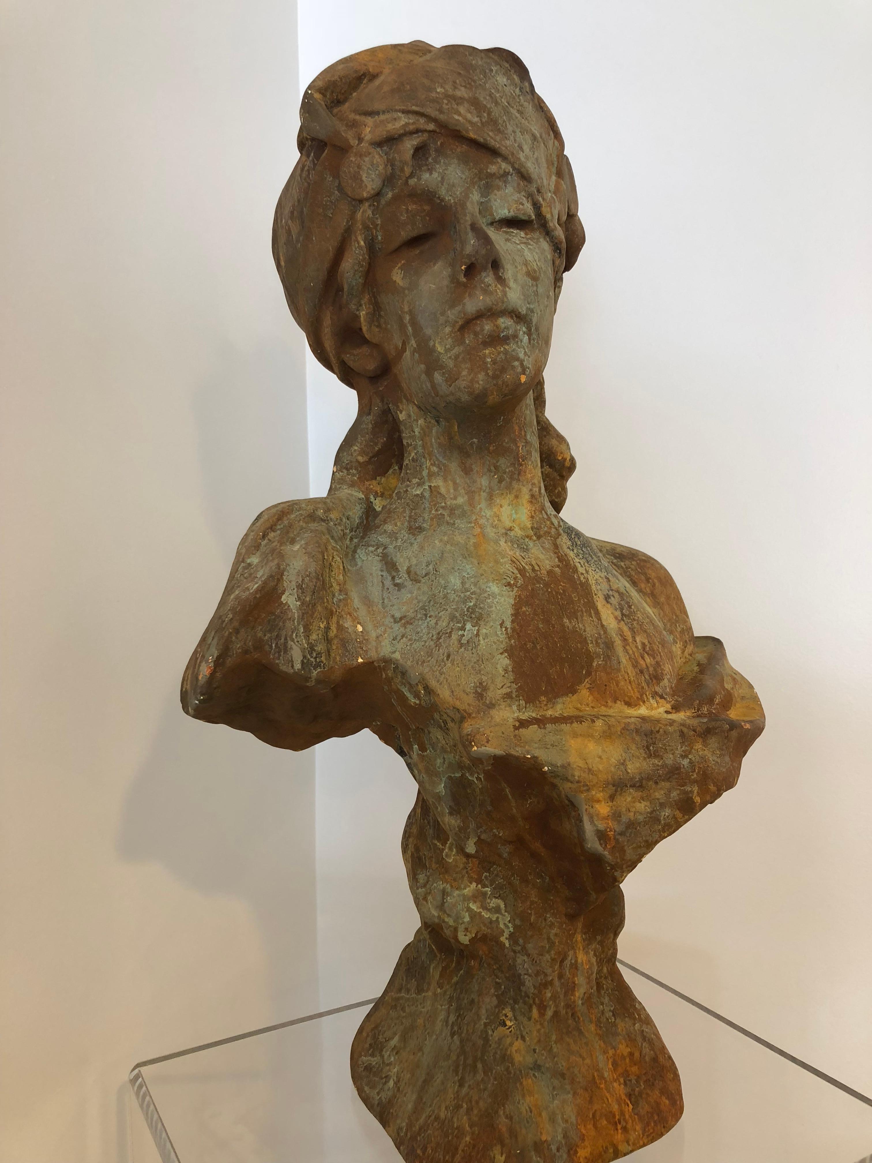 Attractive terracotta carved bust of a French Mademoiselle with nice bronze color and perfect hints of green patina. This could be indoor or outdoor decor. Very sturdy.