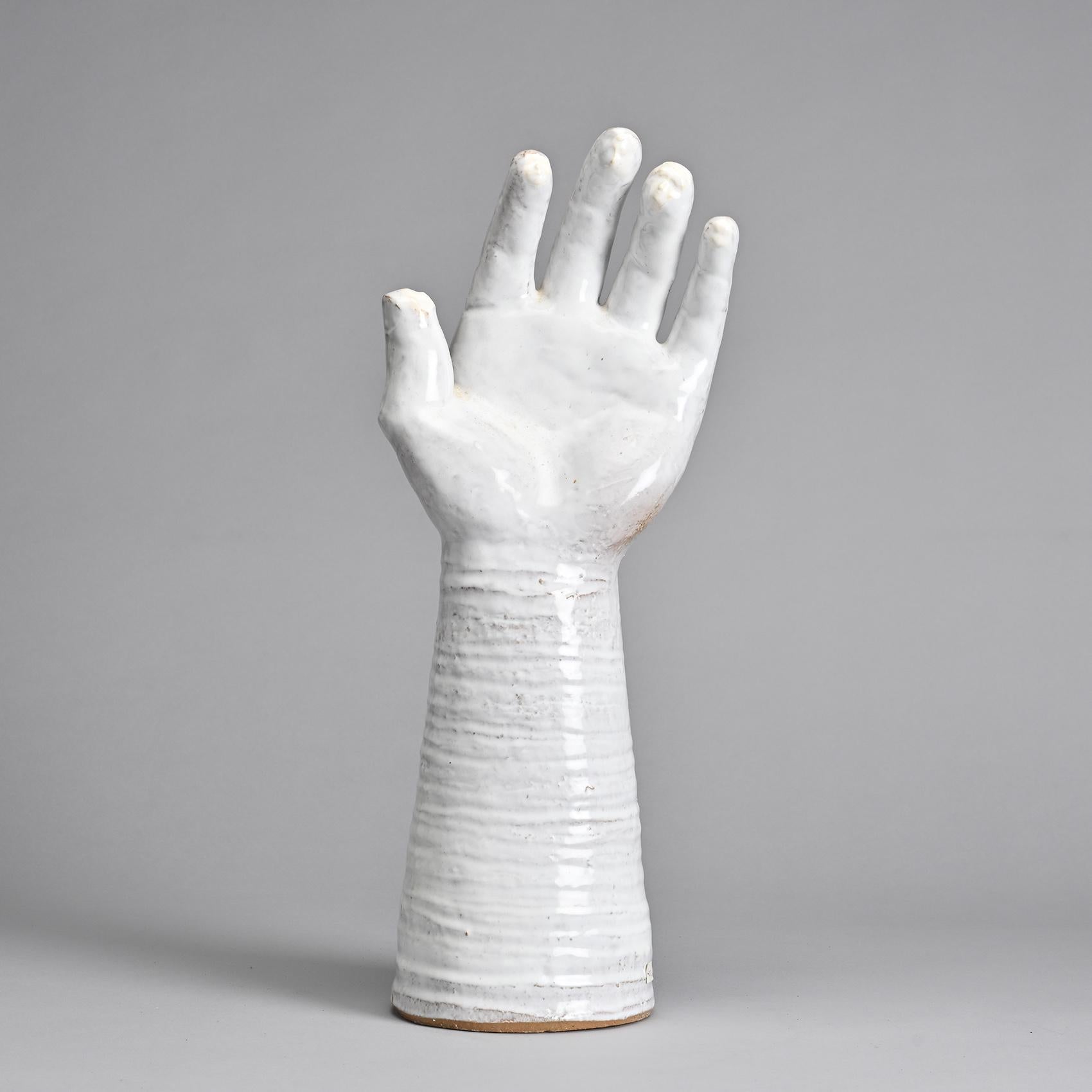 
Unique Piece

Hand with Faces

Created by Robert and Jean Cloutier, twin brothers and French ceramicists, this sculpture depicts an outstretched hand subtly revealing faces at the fingertips. It is made of red clay with a glossy white
