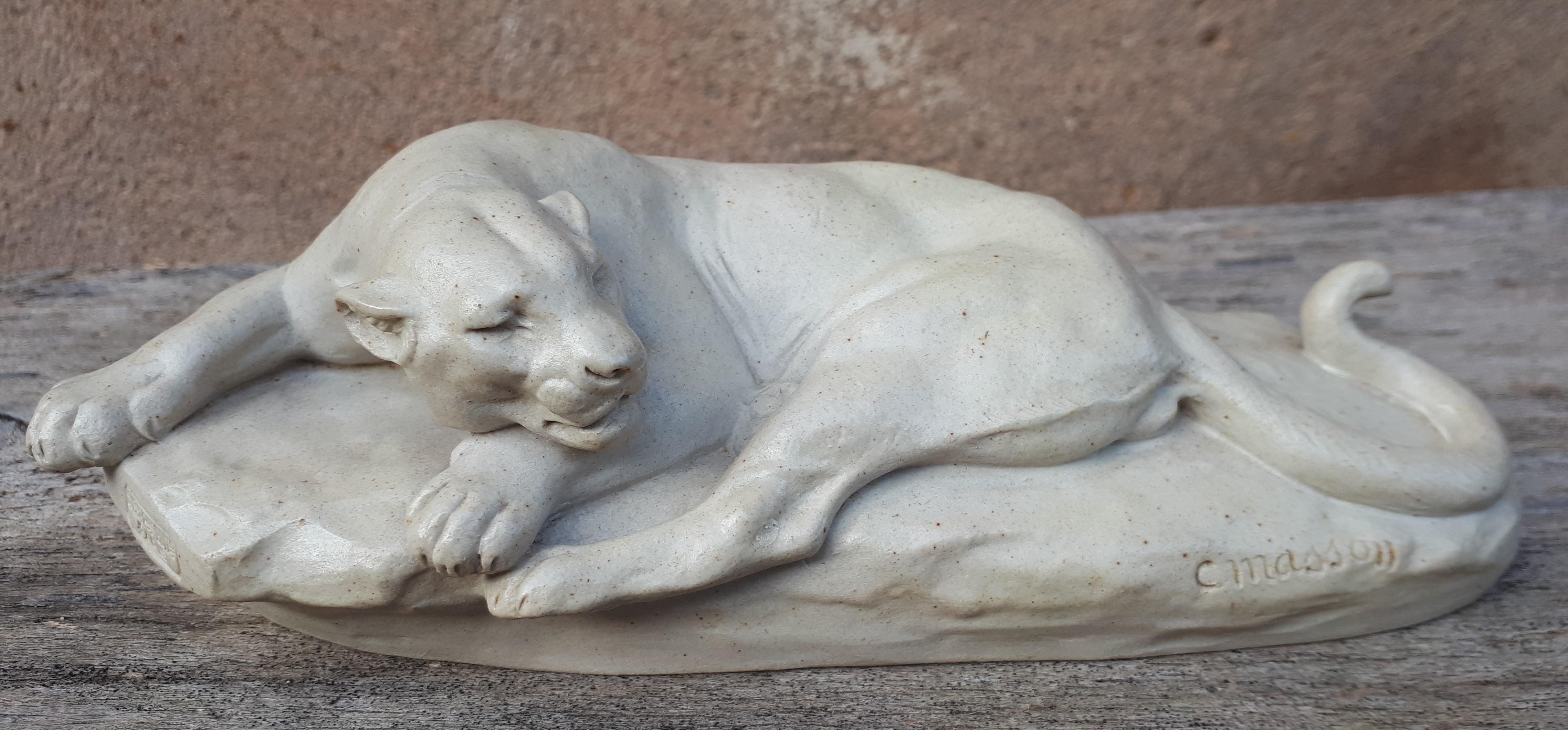 Superb enameled sandstone animal sculpture representing a lioness lying on a rock.
Bears the artist's signature 