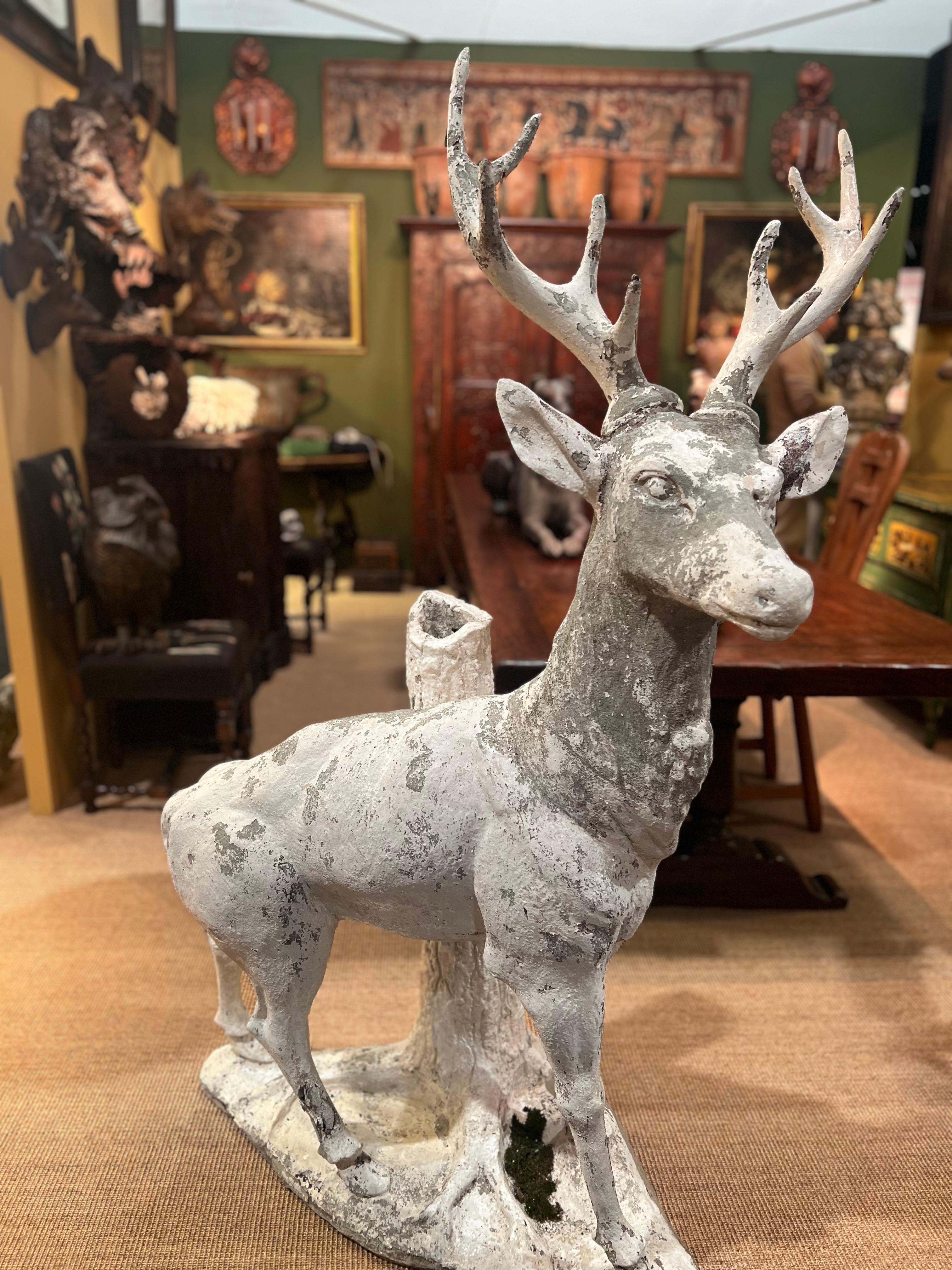 Other Sculpture of a stag in white painted cement standing against a tree trunk For Sale
