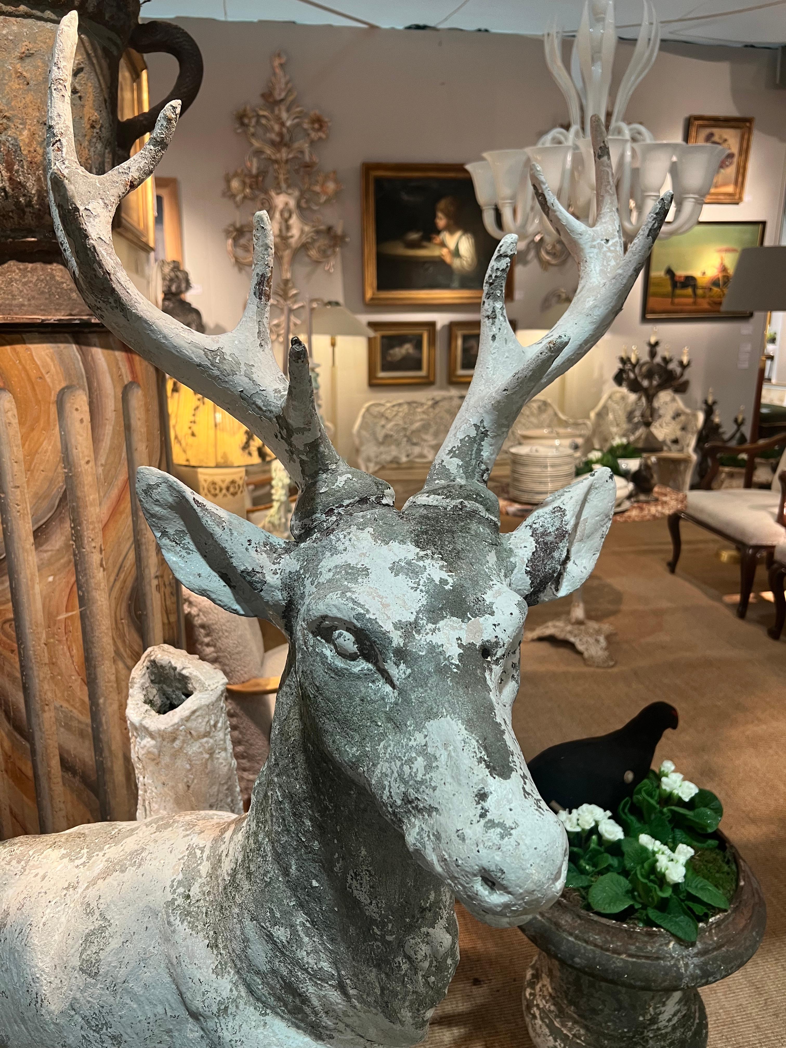 20th Century Sculpture of a stag in white painted cement standing against a tree trunk For Sale