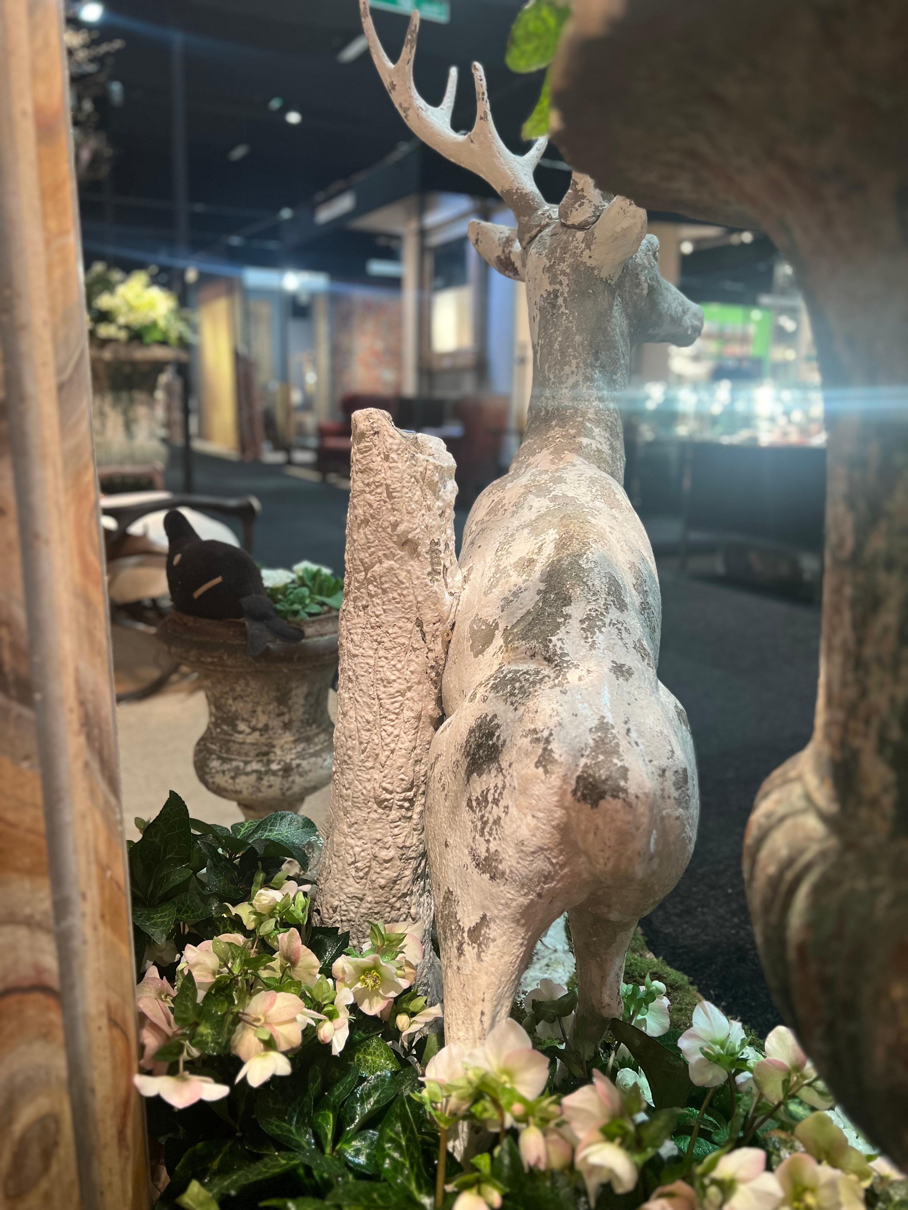 Cement Sculpture of a stag in white painted cement standing against a tree trunk For Sale