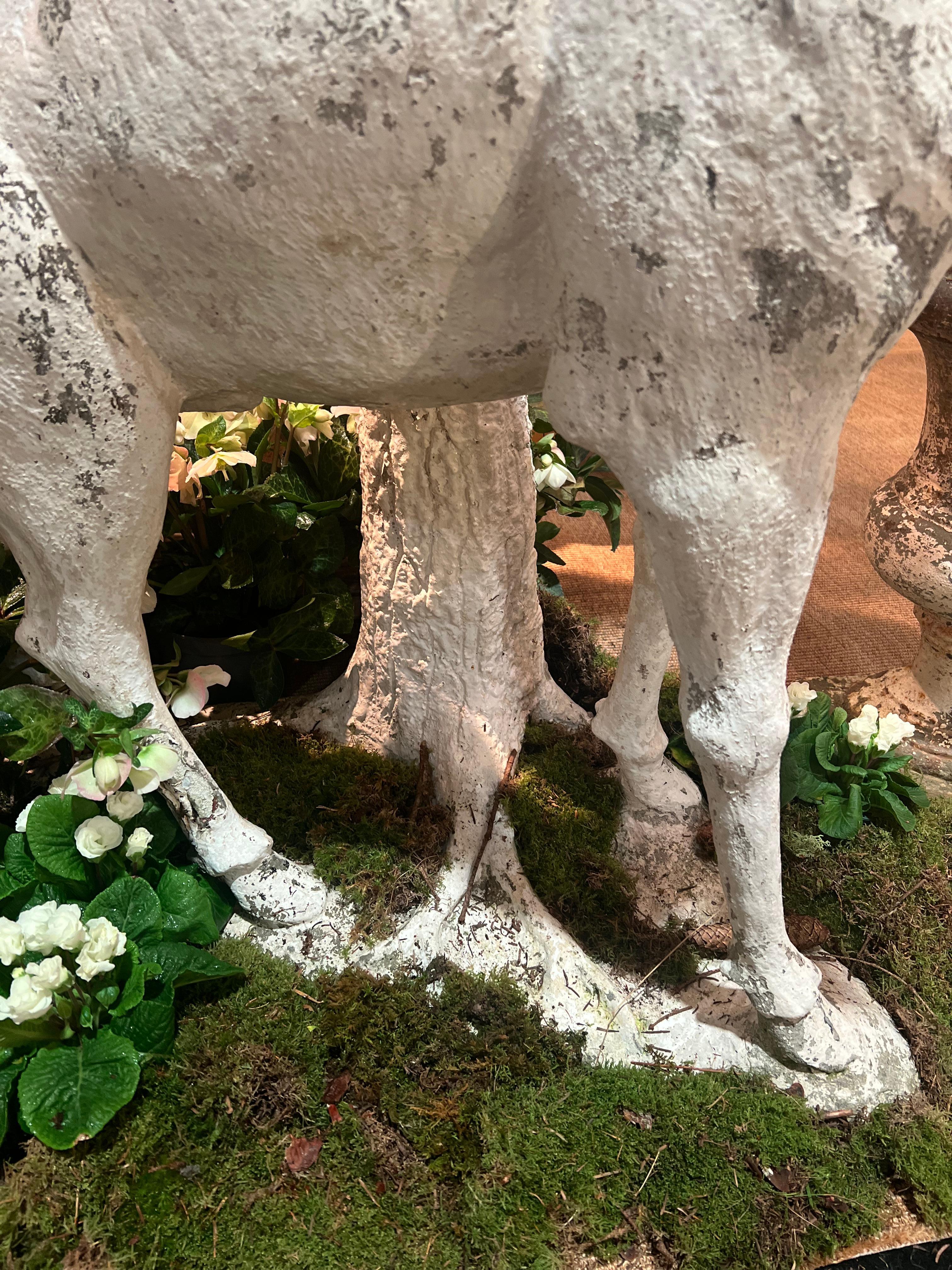 Sculpture of a stag in white painted cement standing against a tree trunk For Sale 1
