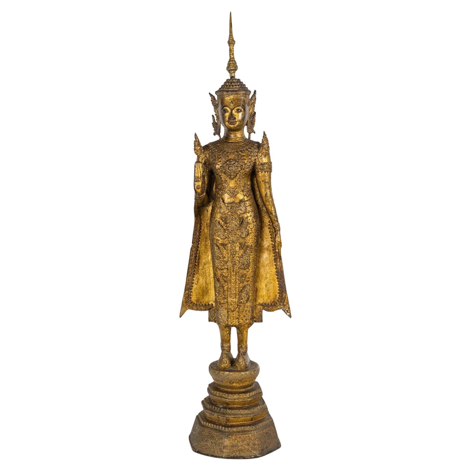 Sculpture of a Standing Buddha in Chased and Gilded Bronze, 18th Century.