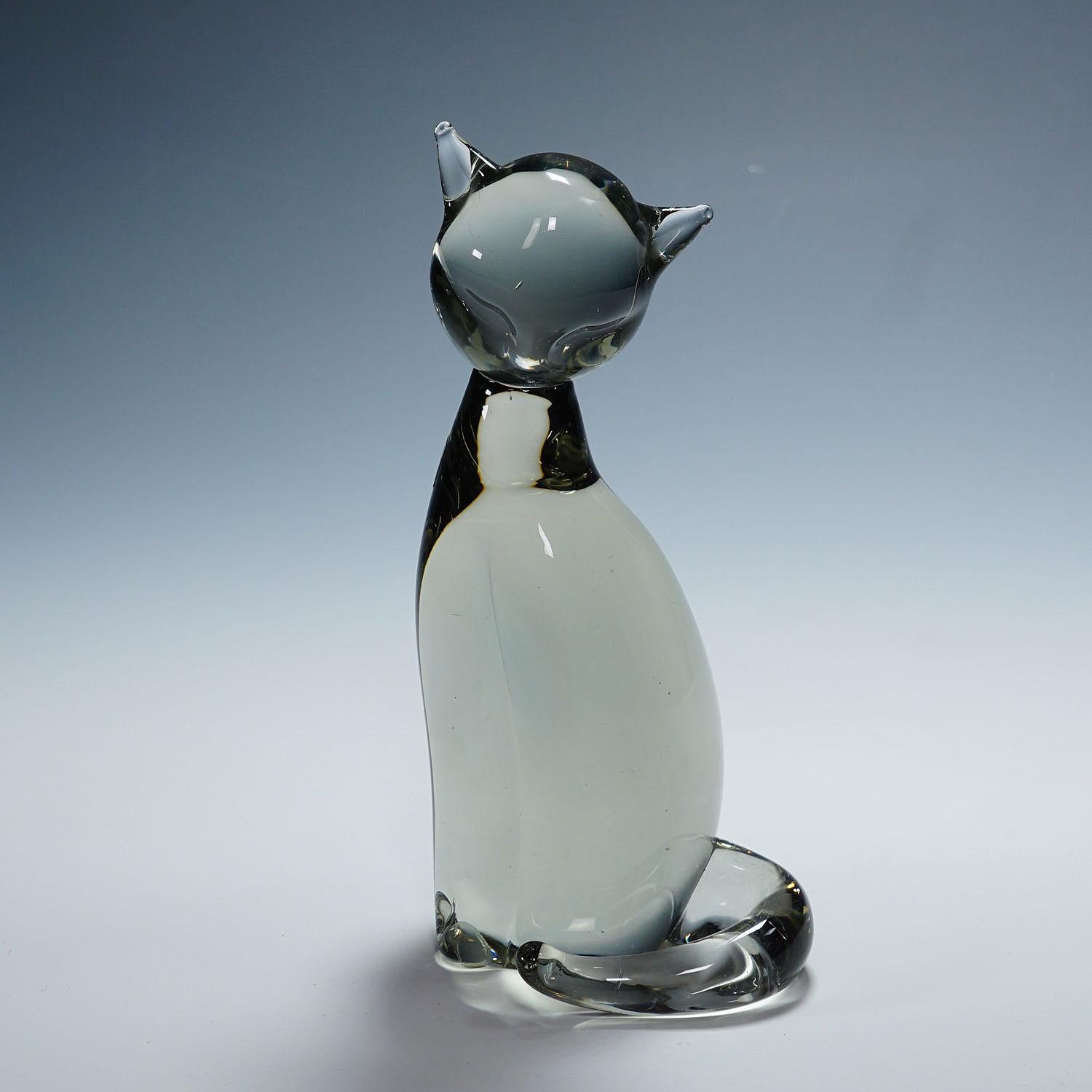 Sculpture of a Stylized Cat Designed by Livio Seguso ca. 1970s

A cute sculpture of a stylized cat in smoke grey glass. Hand made in the Gral glass manufactory, Germany. It was designed by Livio Seguso ca. 1970. The body is with factory lable and