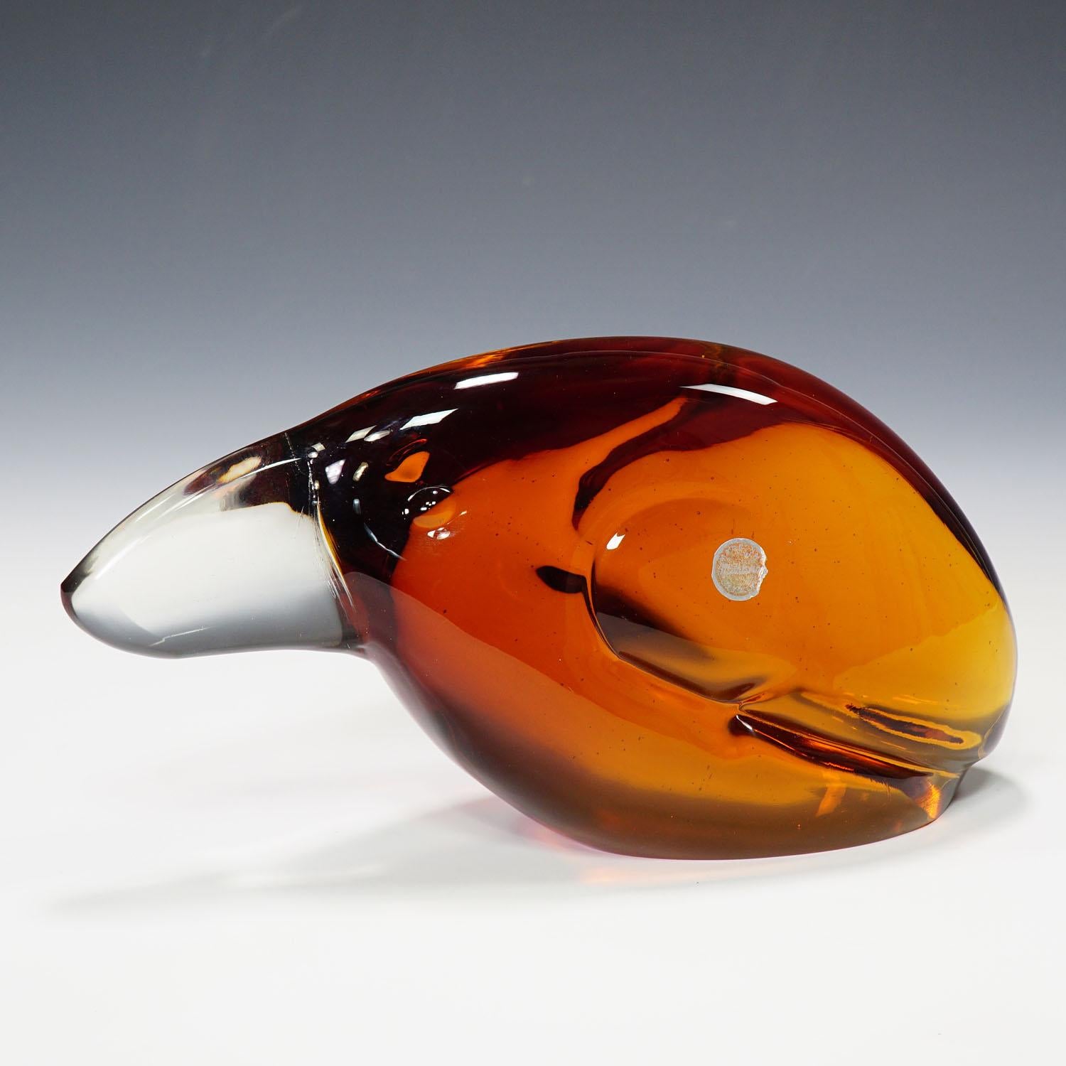 A heavy sculpture of a toucan in orange and clear glass. Designed by glass sculptor Livio Seguso ca. 1960. On the base with incised signature of the artist (LS) and made in Murano sticker on the body. Just another impressive example of his