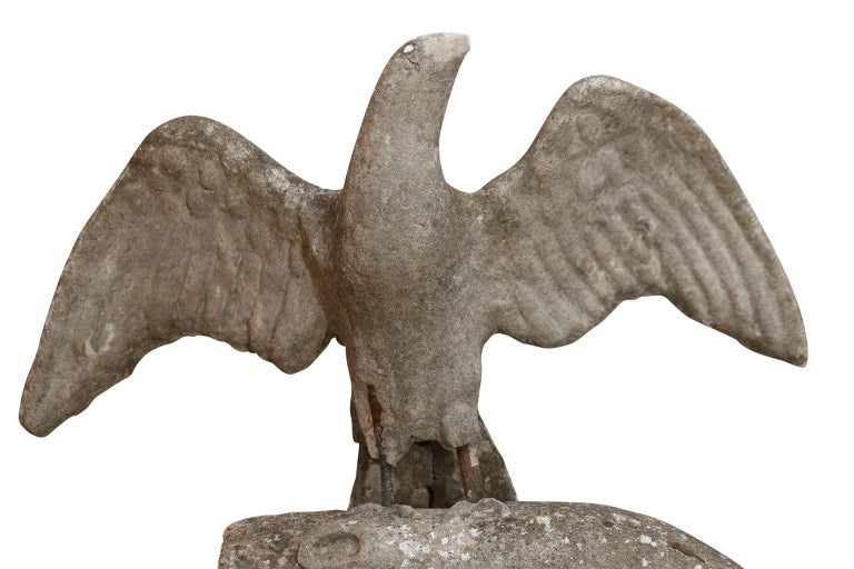 Sculpture of hawk perched upon tree, masterfully executed in concrete. Large scale and impressive, this evocative sculpture is suitable for display in both indoor and outdoor settings.