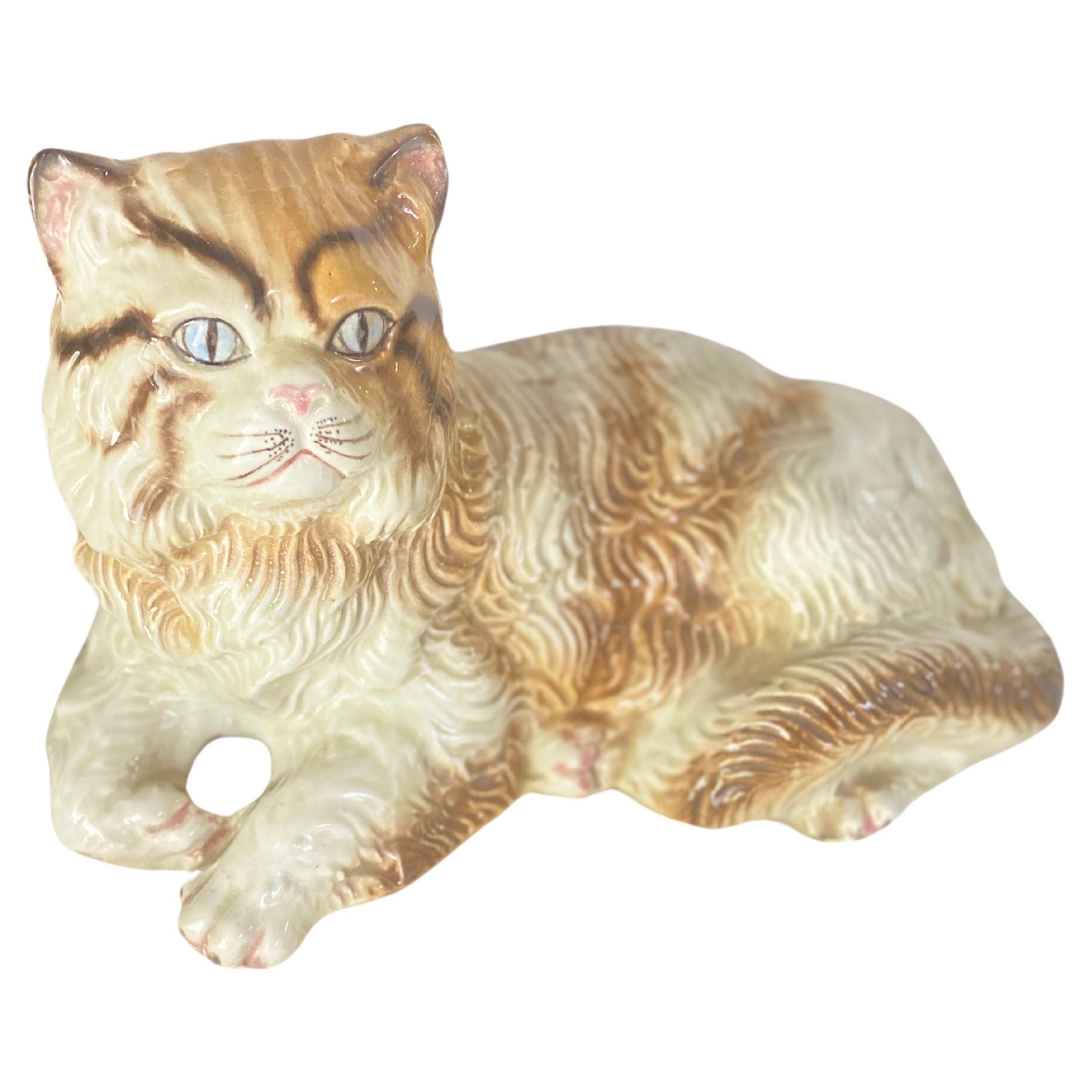 This is a vintage terracotta from Italy representing a seated Cat. You can see realism in the mouth the eyes and the teeth.
The colors are Brown white  and blue. This sculpture has been realised in the 1970s years.
