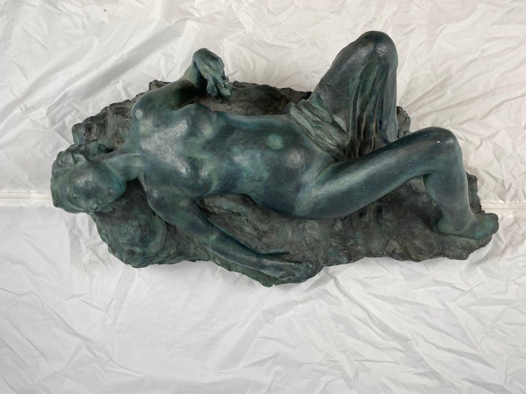 A plaster sculpture depicting a laying woman signed and dated 1903. Otto Strandman (1871-1960) was a Swedish sculptor that exhibited on many of the large exhibitions in the first half of the 20th century, among them the Baltic exhibition in Malmö
