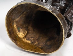 Escultura que representa a una mujer sentada en una roca de Léon Pilet