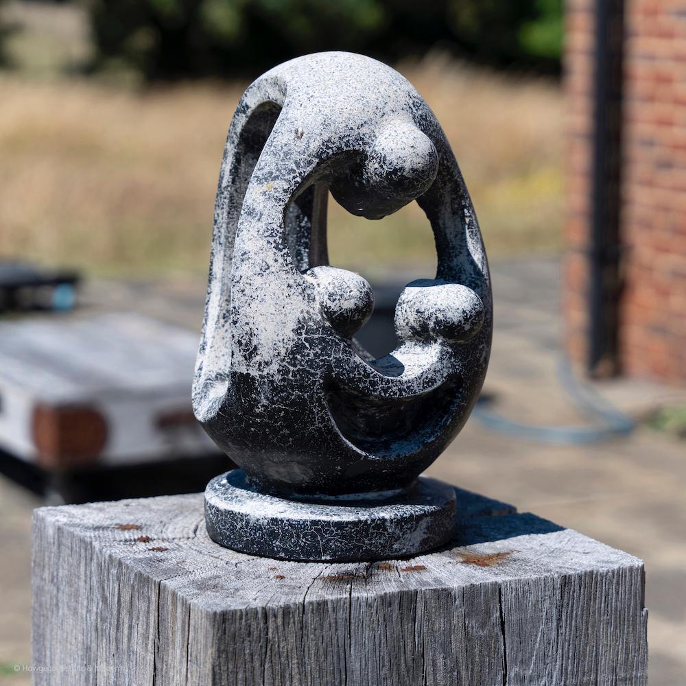 A 17“ high, modernist, biomorphic, stone sculpture, of a Mother Holding Two Children, mid-20th century. Artist unknown. Private Collection.

This sculpture is equally striking displayed inside or outside within a landscape. 