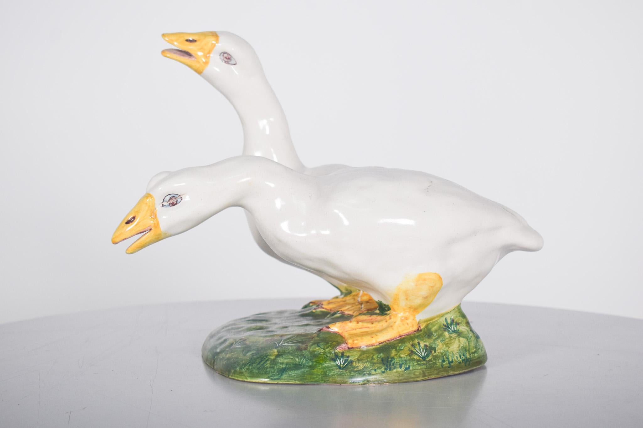 Skulptur, zwei Enten aus Sant'Anna-Fayence. Das Werk zeichnet sich durch einen detaillierten Realismus aus, der den dynamischen Ausdruck und die Körperhaltung der Vögel hervorhebt. Eine der Enten hält den Kopf hoch, mit offenem Schnabel, während die