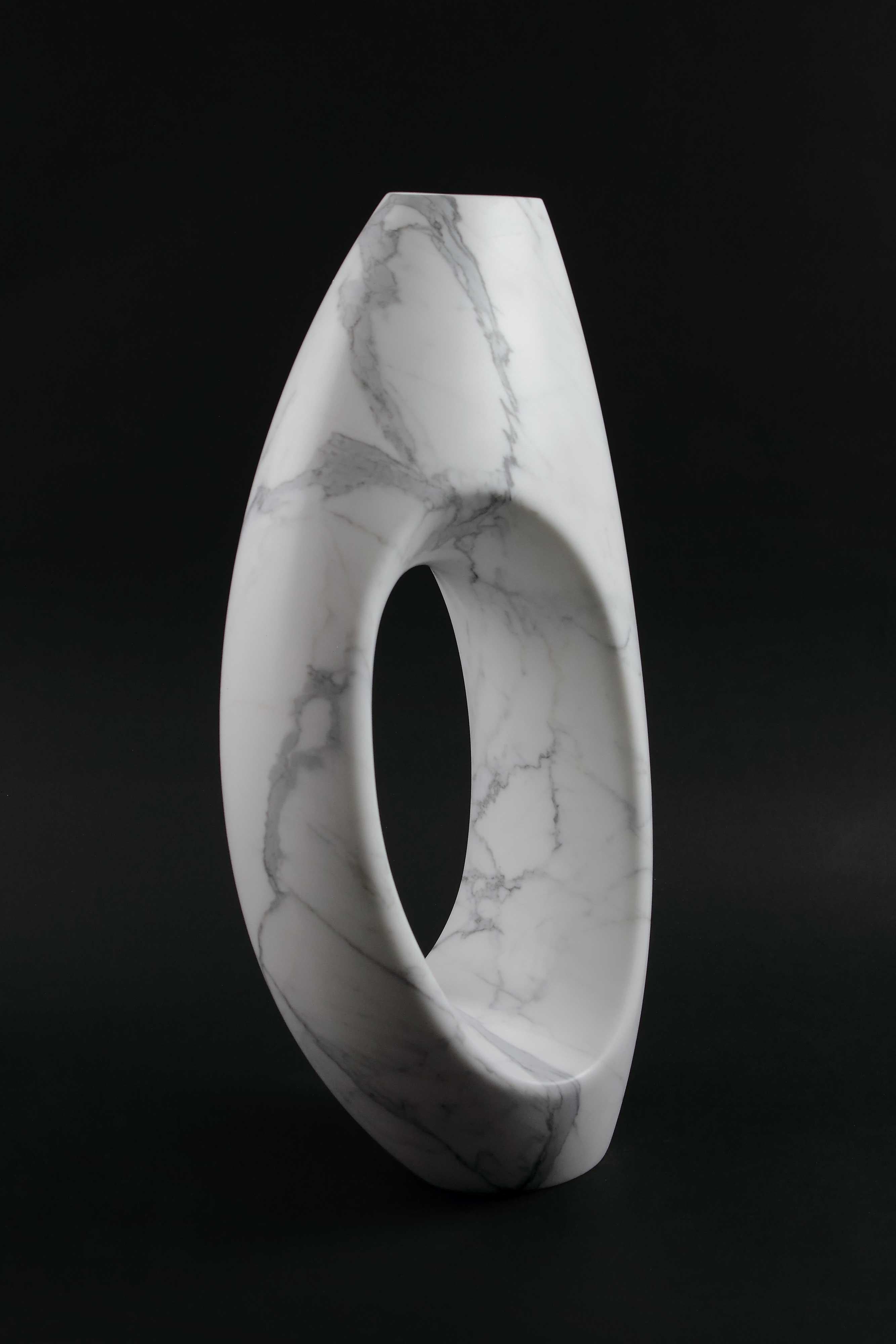 Important sculptural vase carved by hand from a solid block of Statuary marble. The precious white Statuary marble has always been the one preferred by sculptors and artists for their artworks. Known throughout the world, this beautiful marble has