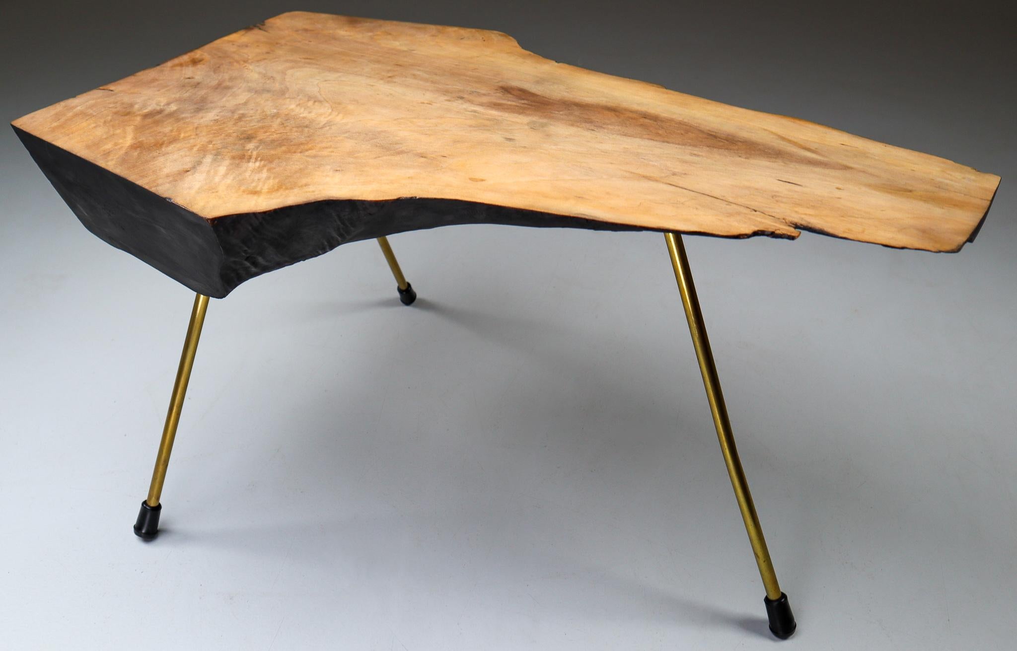 A sculptural tree trunk coffee table by Austrian designer Carl Auböck II (often simply referred to as Carl Auböck), from circa 1950s. A large tree trunk table designed and made by the Auböck Werkstätte, circa 1950s. The modernist table is made of
