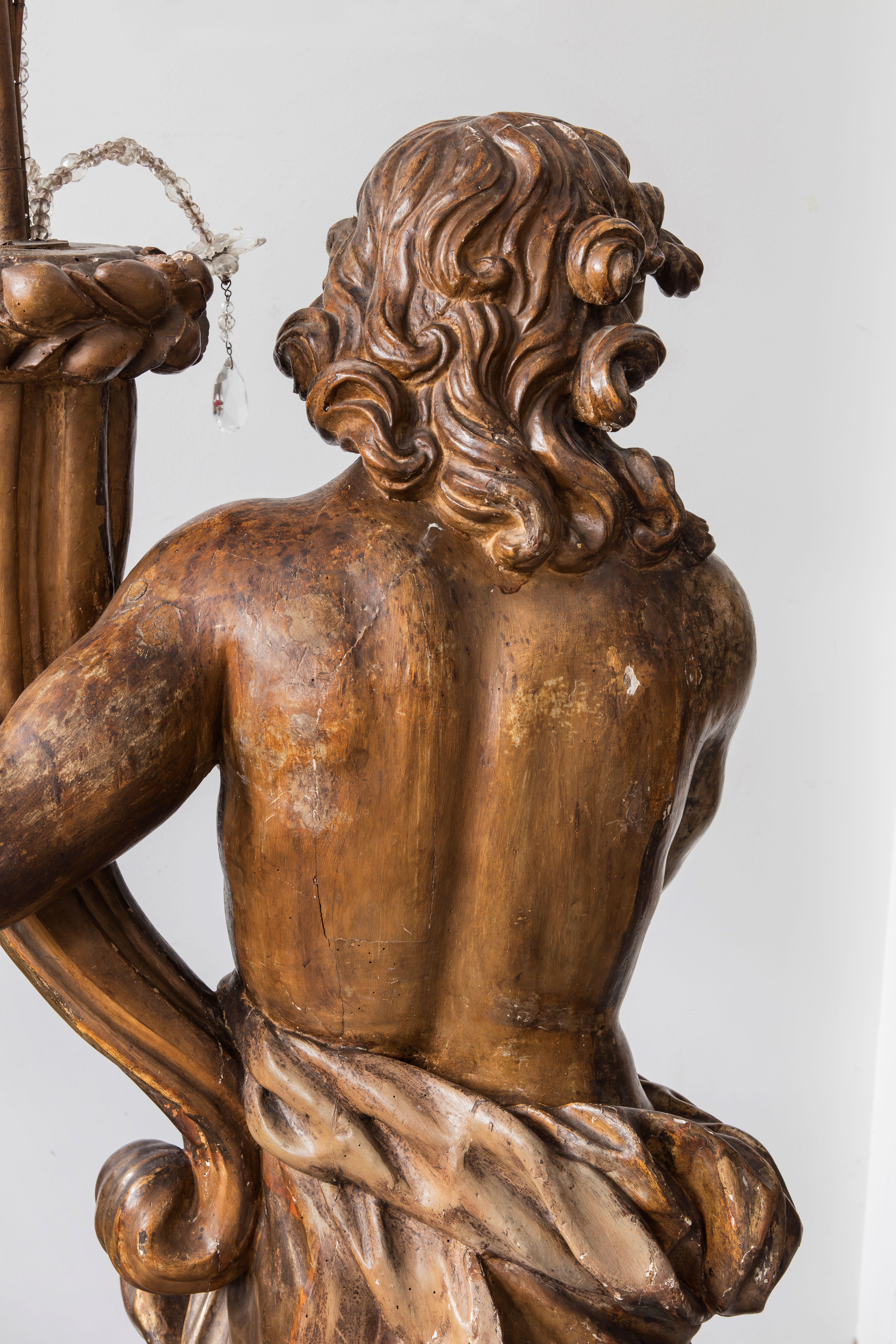 Italian sculptor of the 17th century, 
pair of candlesticks                                                                                                                                     carved and gilded wood modeled as genuflected male